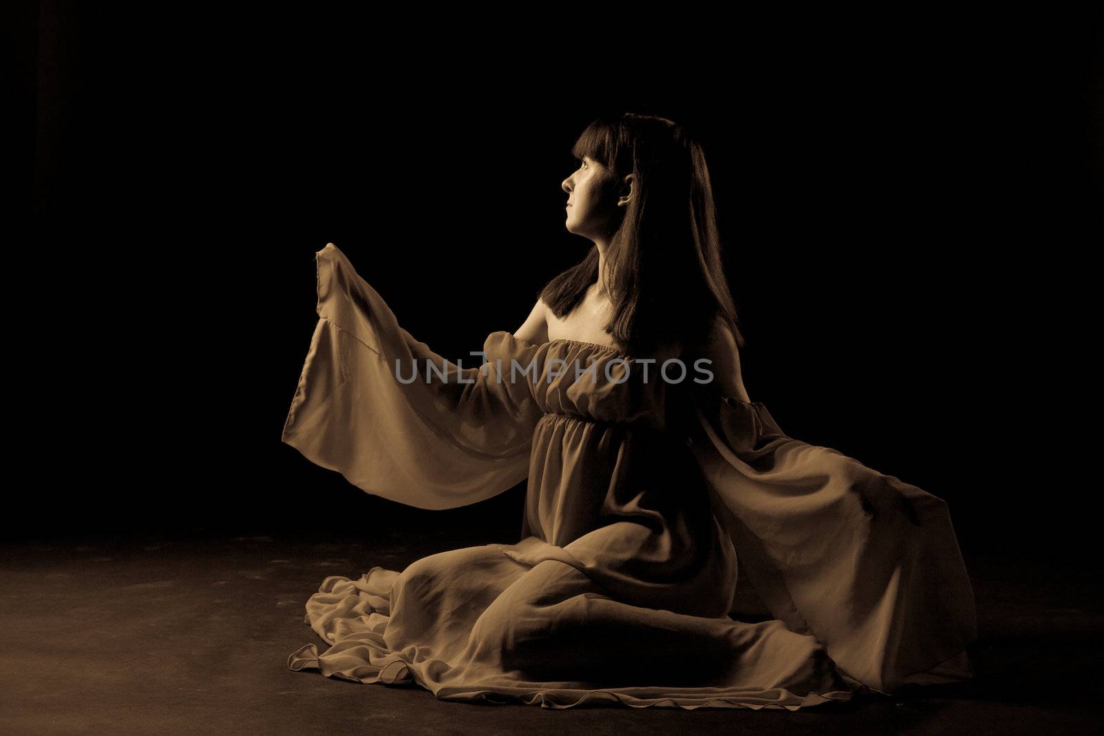 Young girl dancer in a darkness before start
