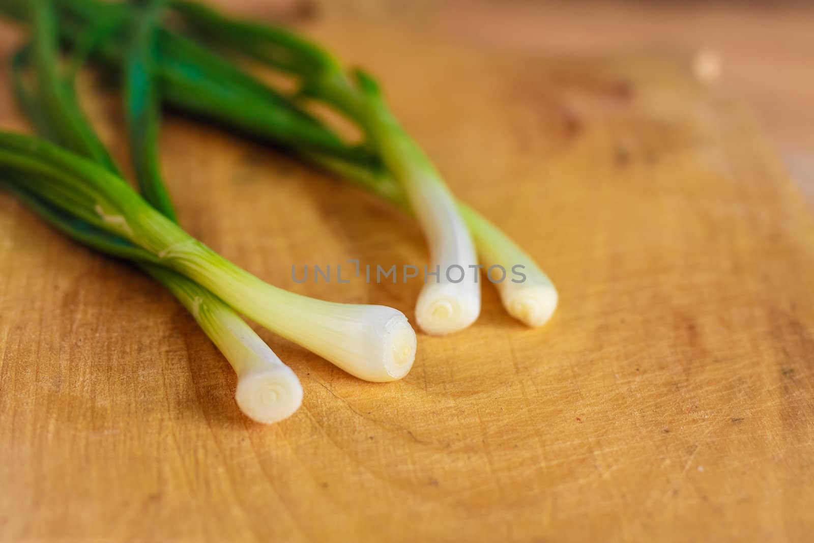 Spring Green Onions Group On Wooden Desk. Selective Focus