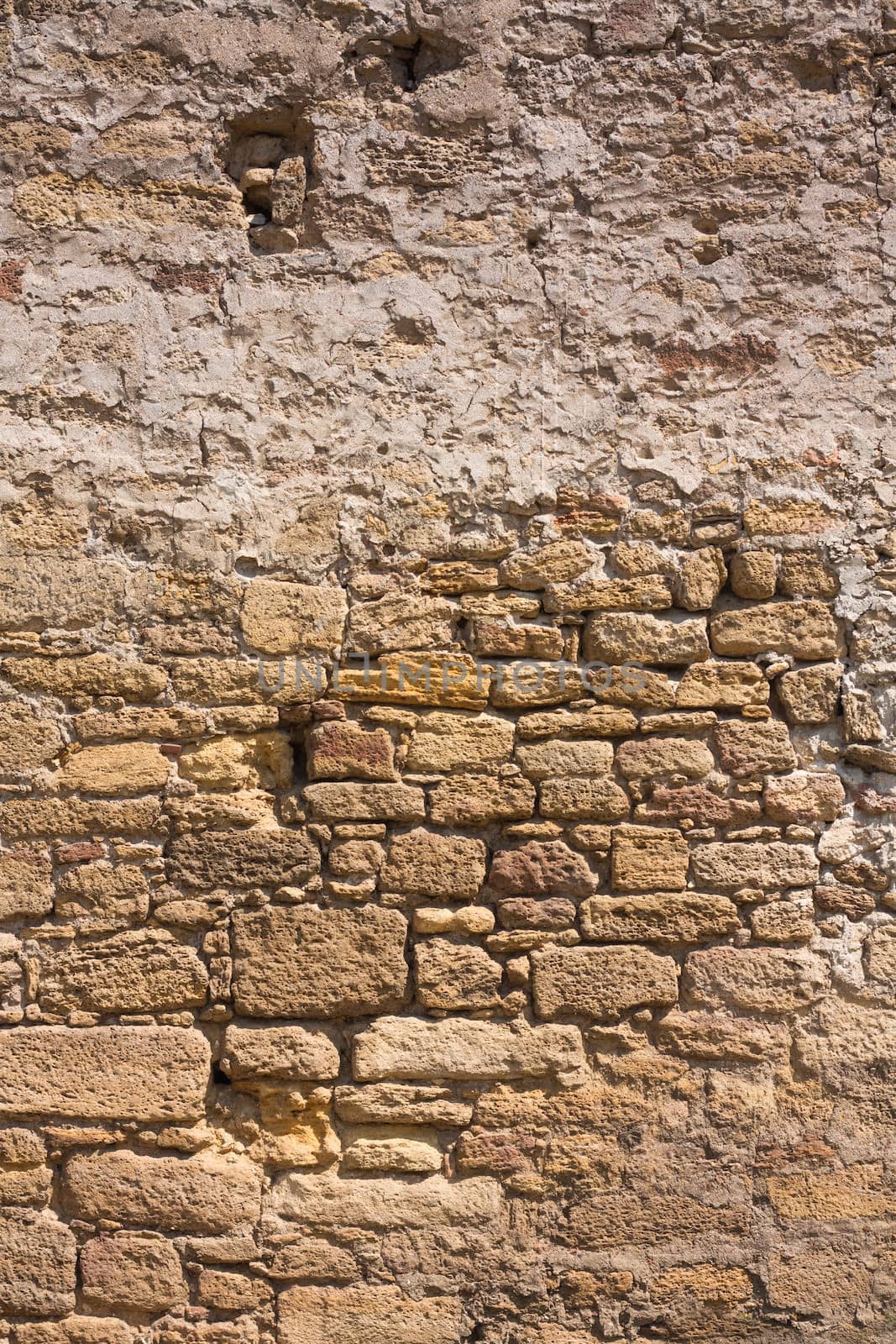 Old wall made of the Jerusalem stone. Wall constructed of stone bricks.