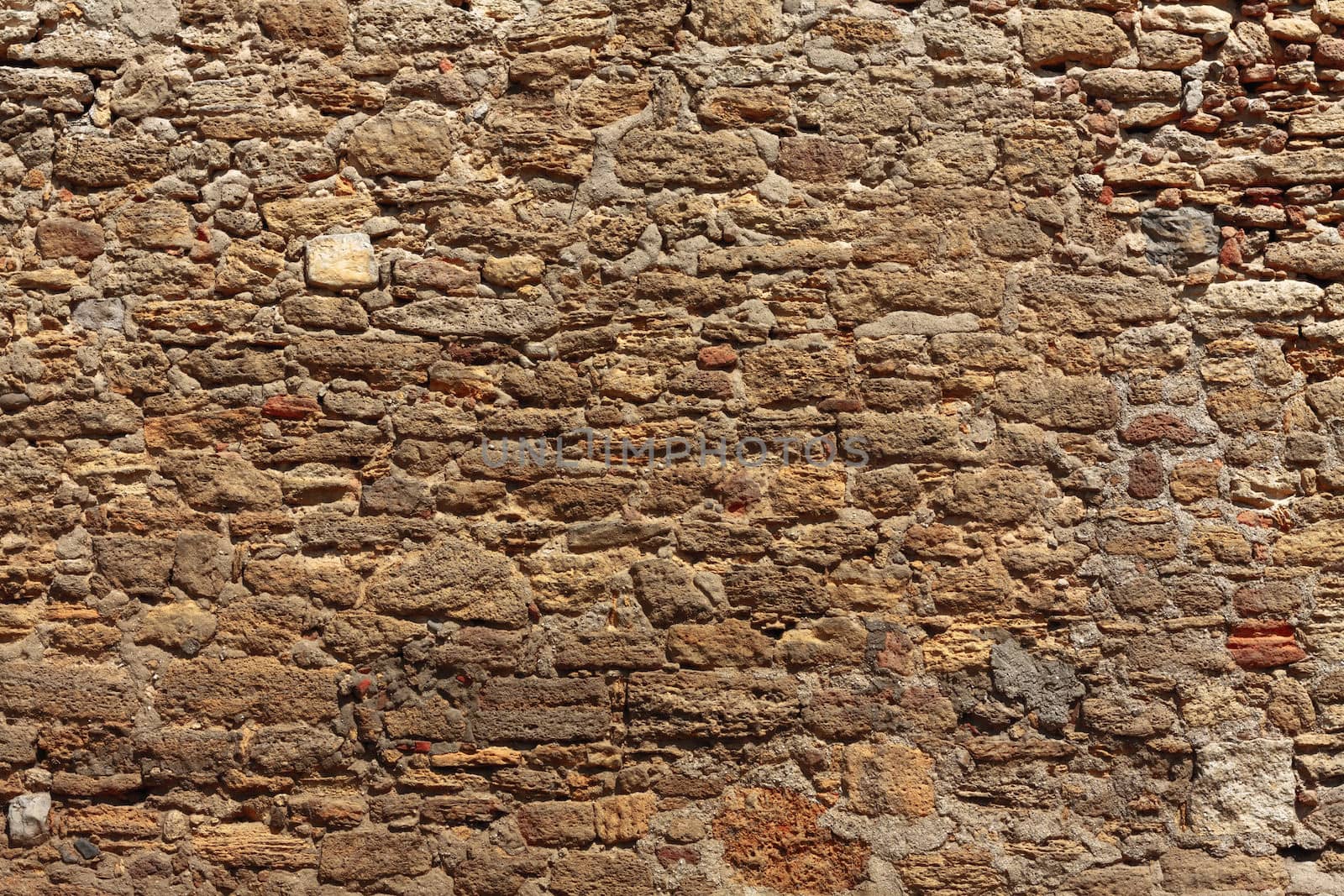 Old wall made of the Jerusalem stone. Wall constructed of stone bricks.