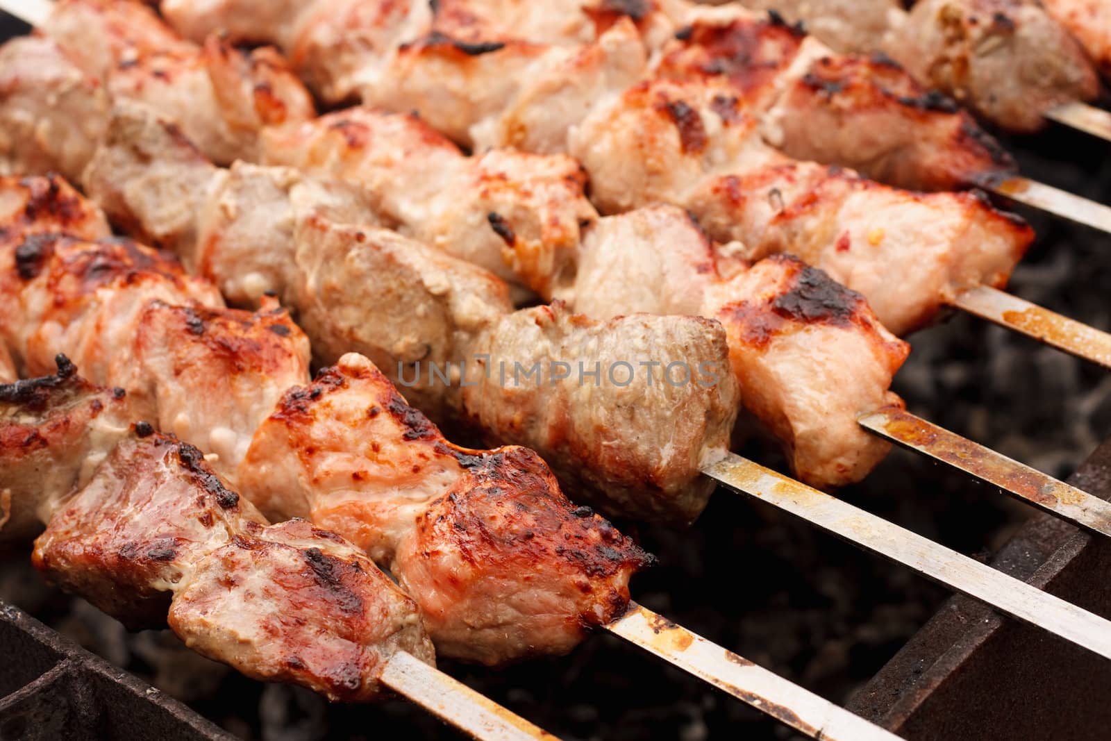 Shish Kebab In Process Of Cooking On Open Fire Outdoors (Shish Kebab, Shashlik).