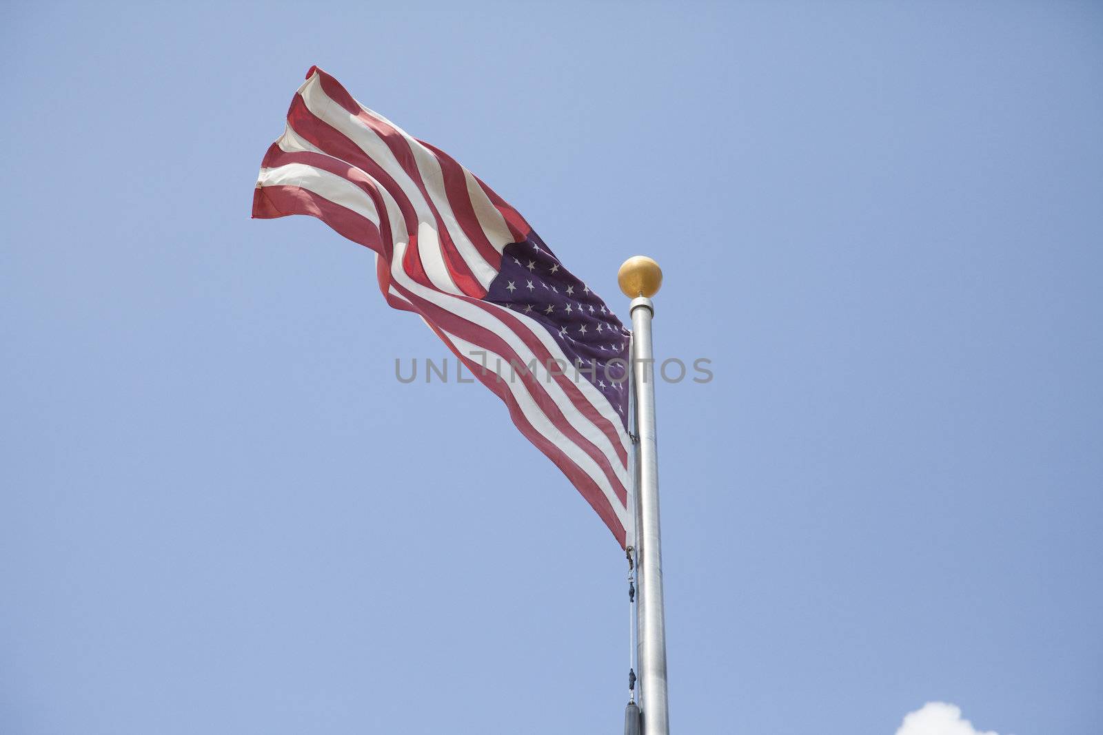 American flag waving in front oblue sky