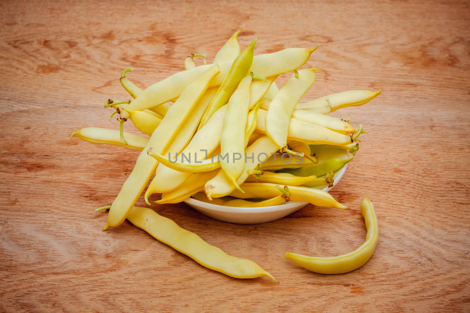 Yellow Kidney Beans In A Bowl On Wooden Table by ryhor