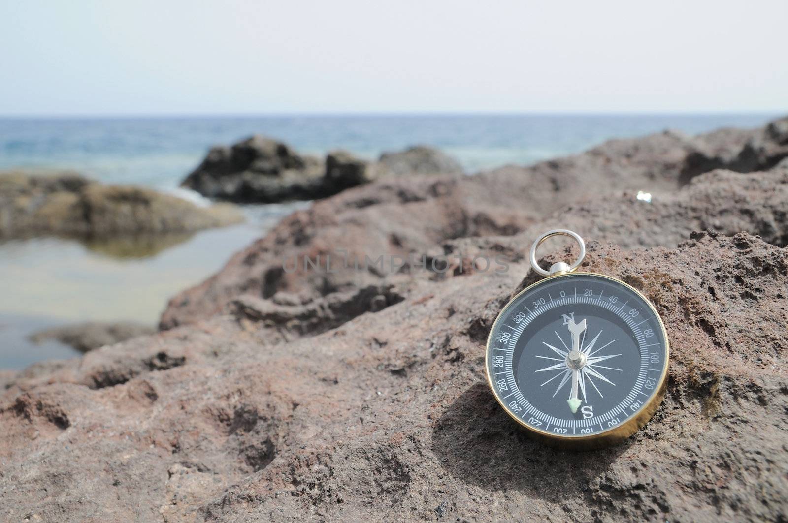 One Compass on the Rocks near the Atlantic Ocean