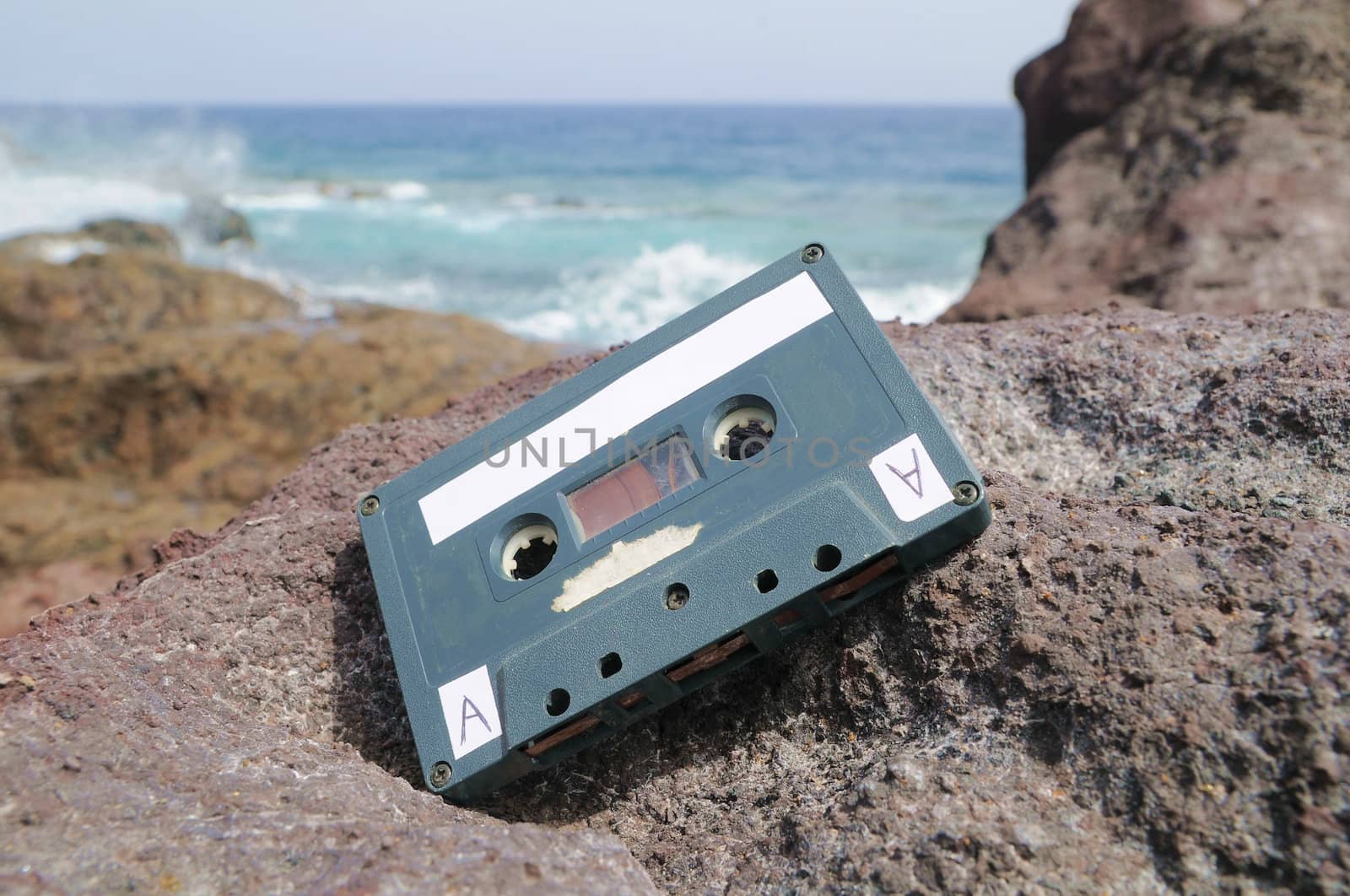 Ancient Retro Musicassette on the Rocks near the Beach