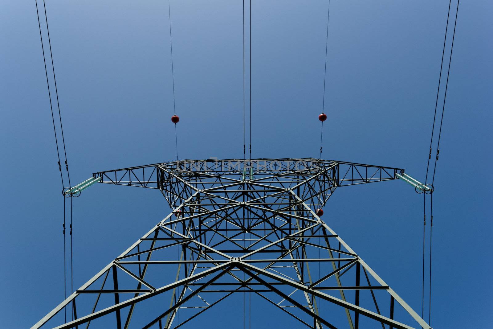 Detail of electricity pylon against blue sky 