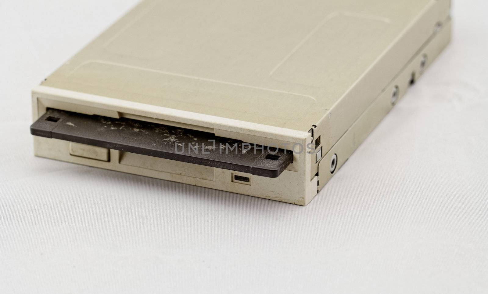 Floppy disk drive and diskette on white background