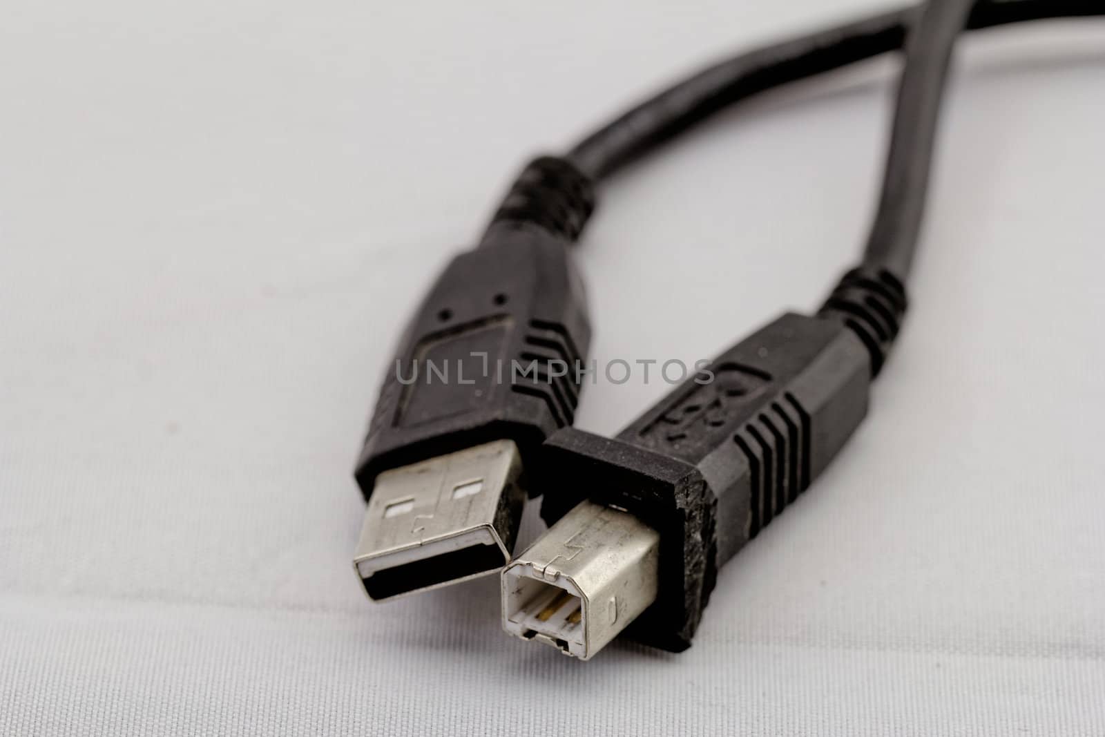 black usb printer cable on white background (a, b)