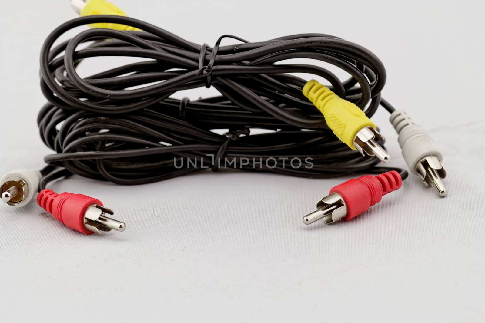 three audio (left - right) - video RCA cable and plug (red, white, yellow) on white background