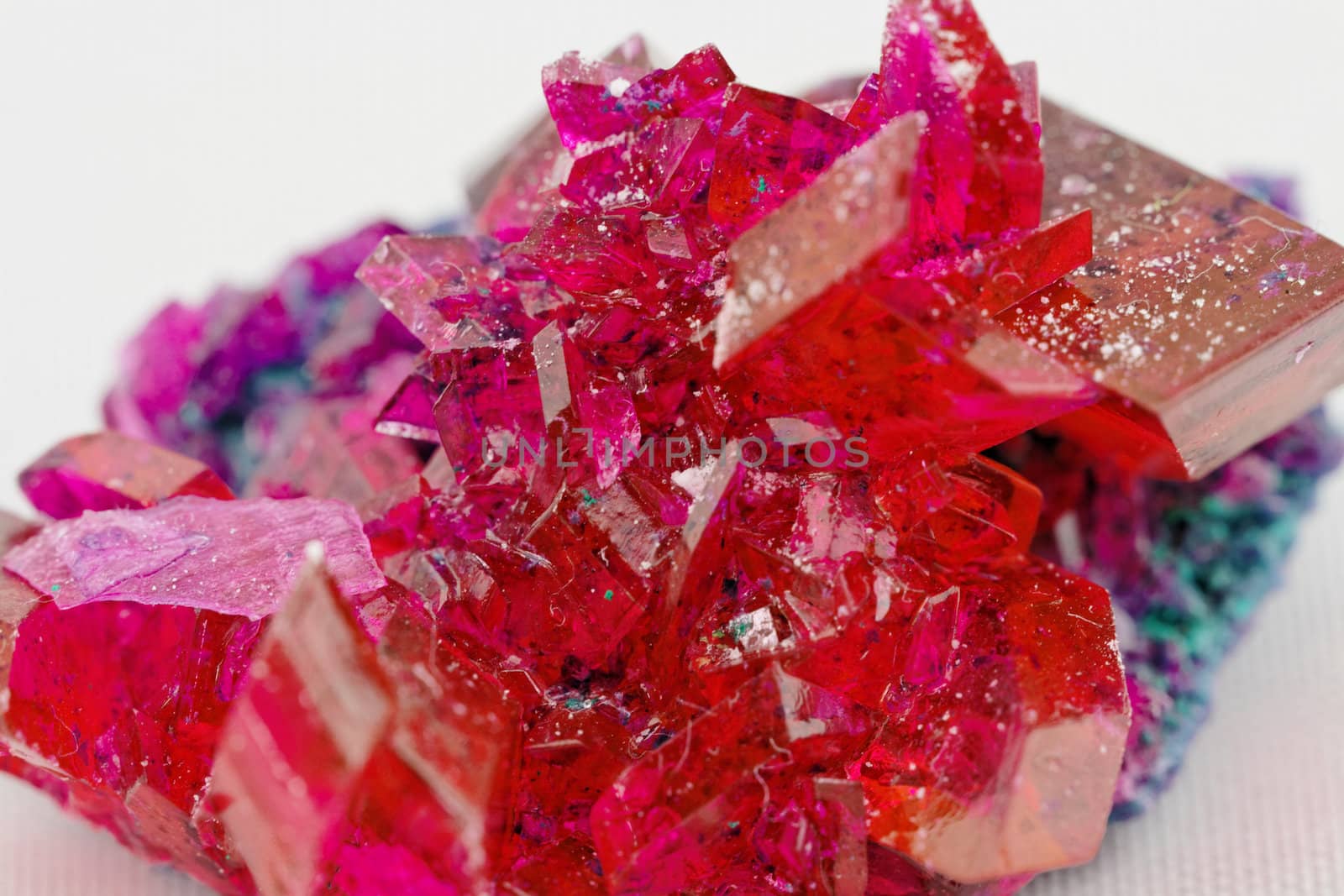 close up of crystals in ruby color on white background (red crystal)