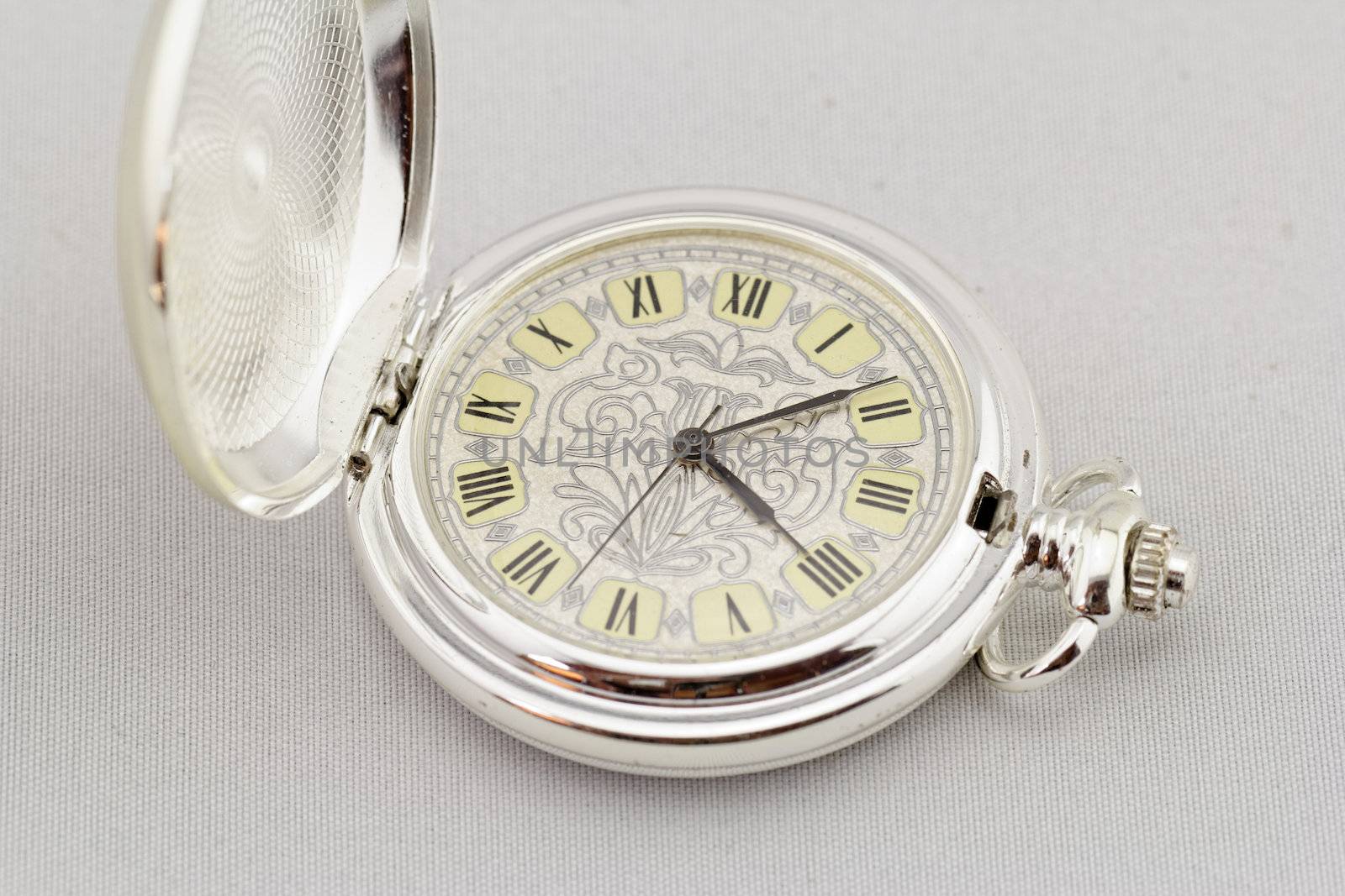 Part of a antique mechanical pocket watch on white background