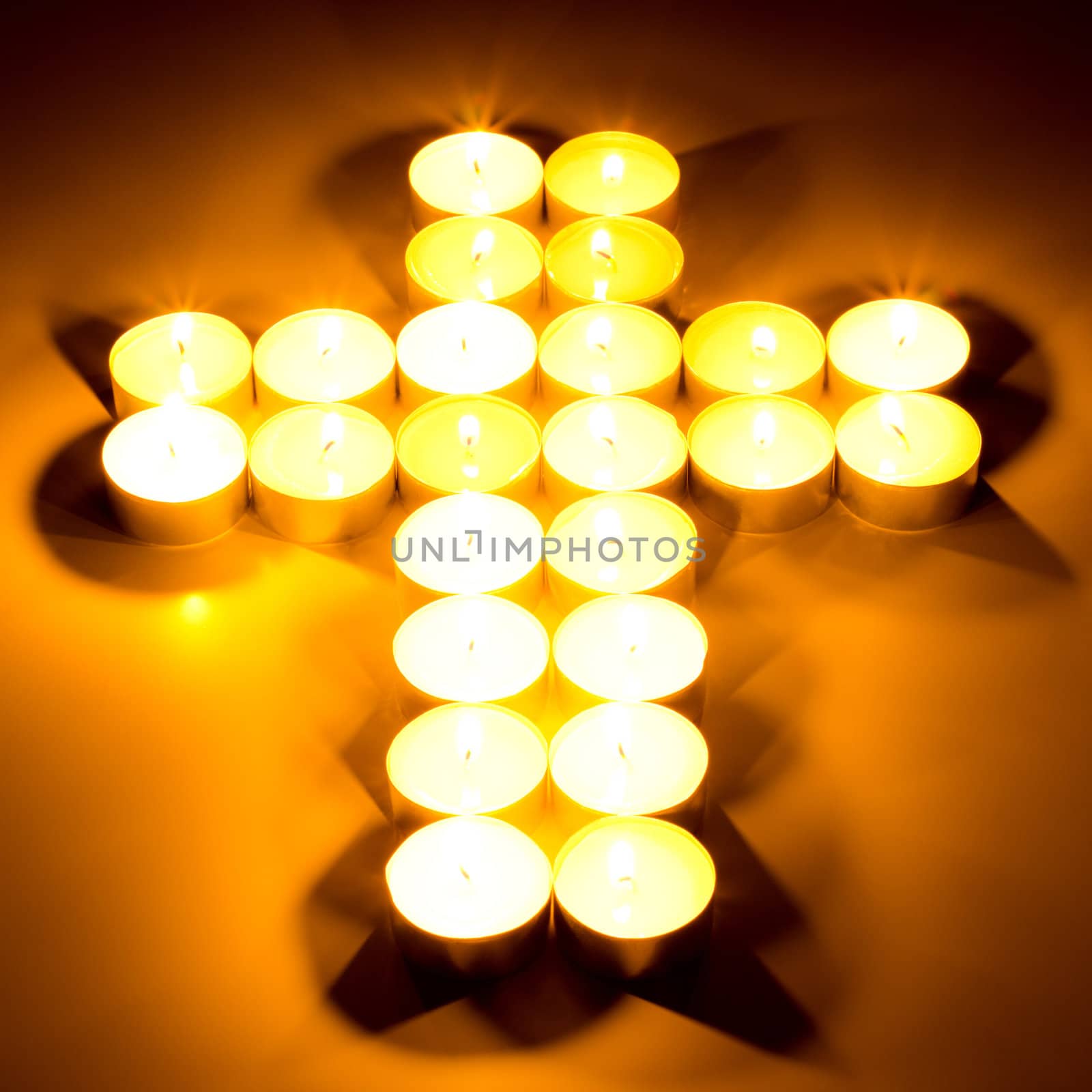 Christian cross made with tea candles by gwolters