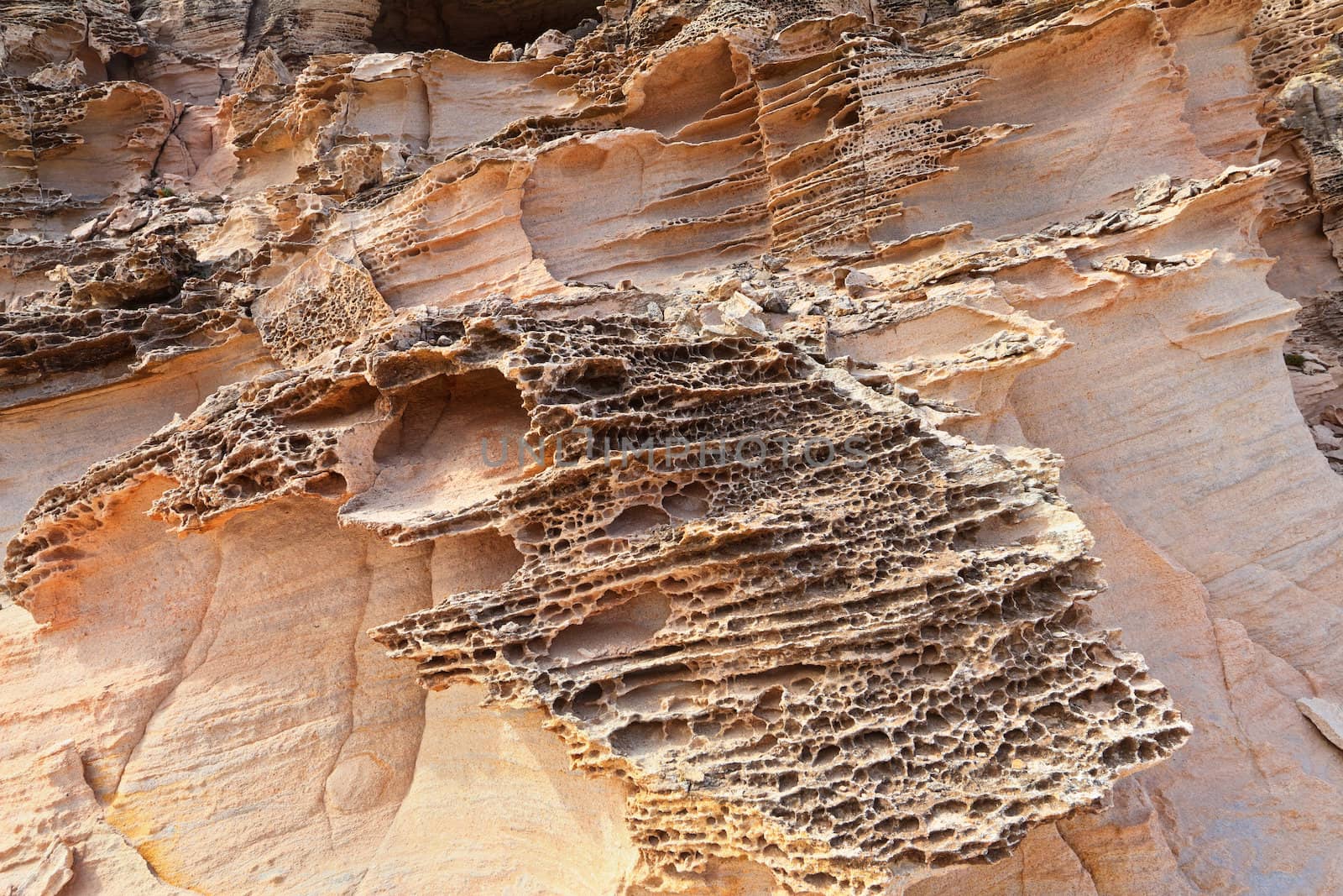 water and wind erosion in pink granite, San Pietro island, Sardinia, Italy