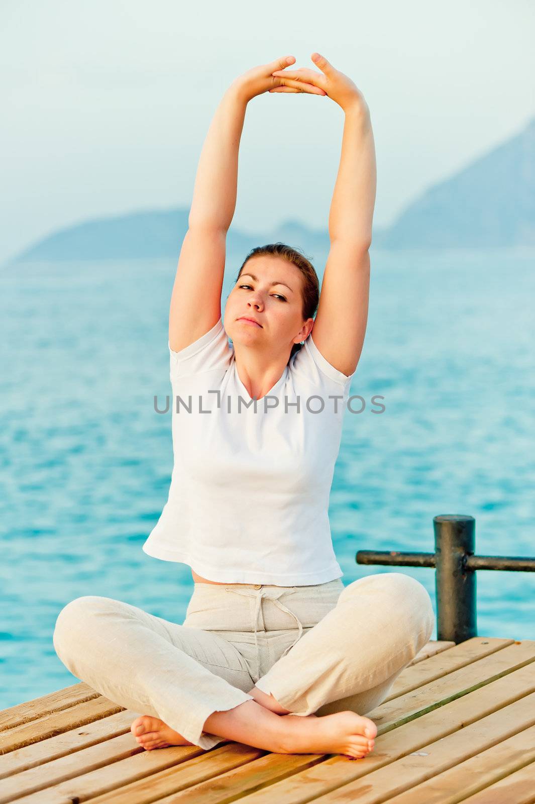 beautiful woman has a banner on a wooden pier by kosmsos111