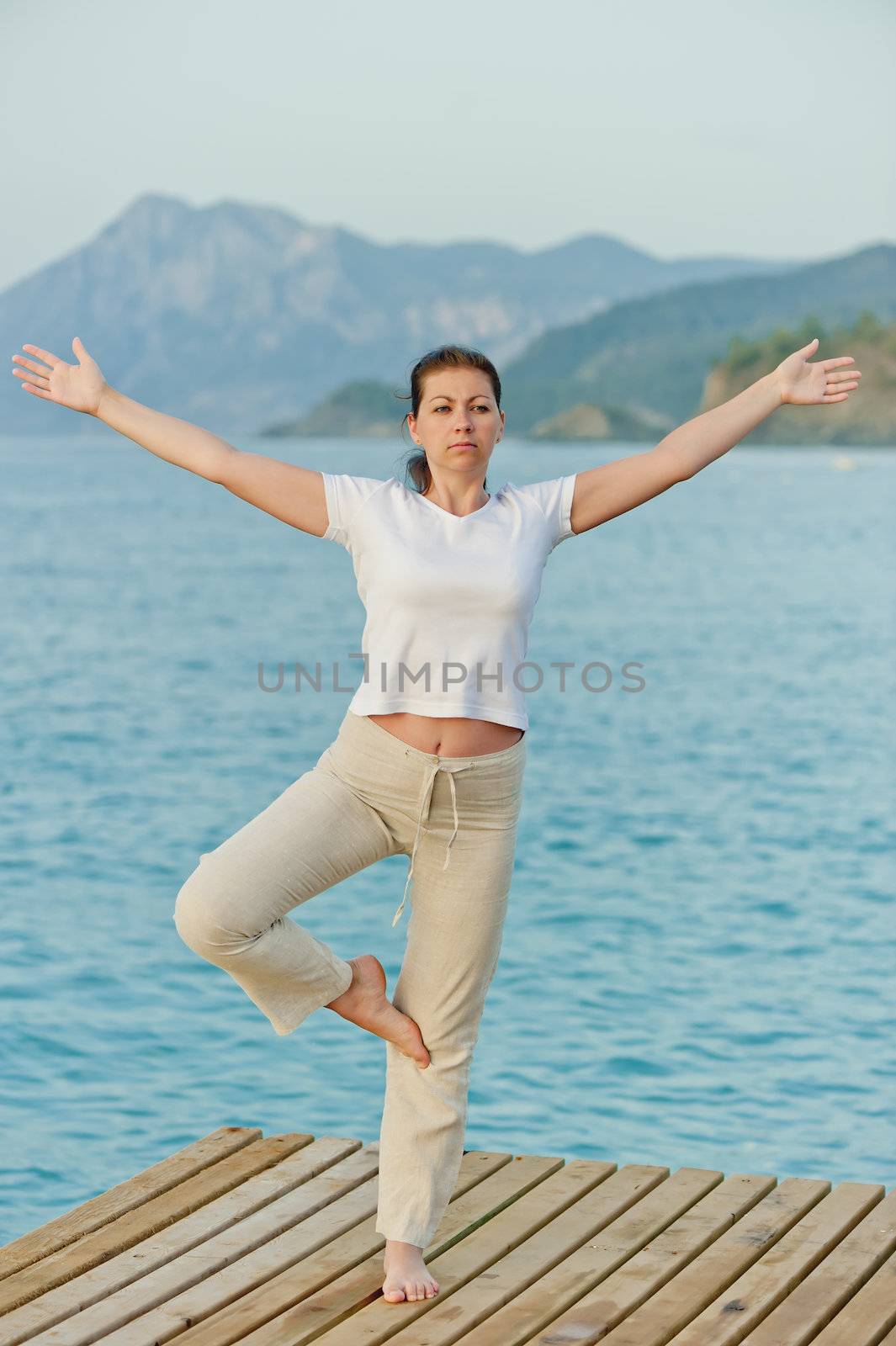 girl standing on one leg with arms outstretched to the sides