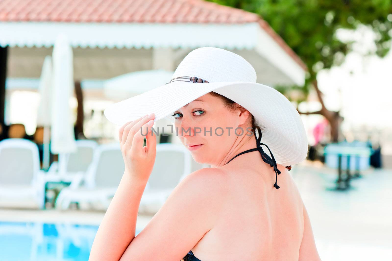 woman in a bikini holds the hand his hat by kosmsos111