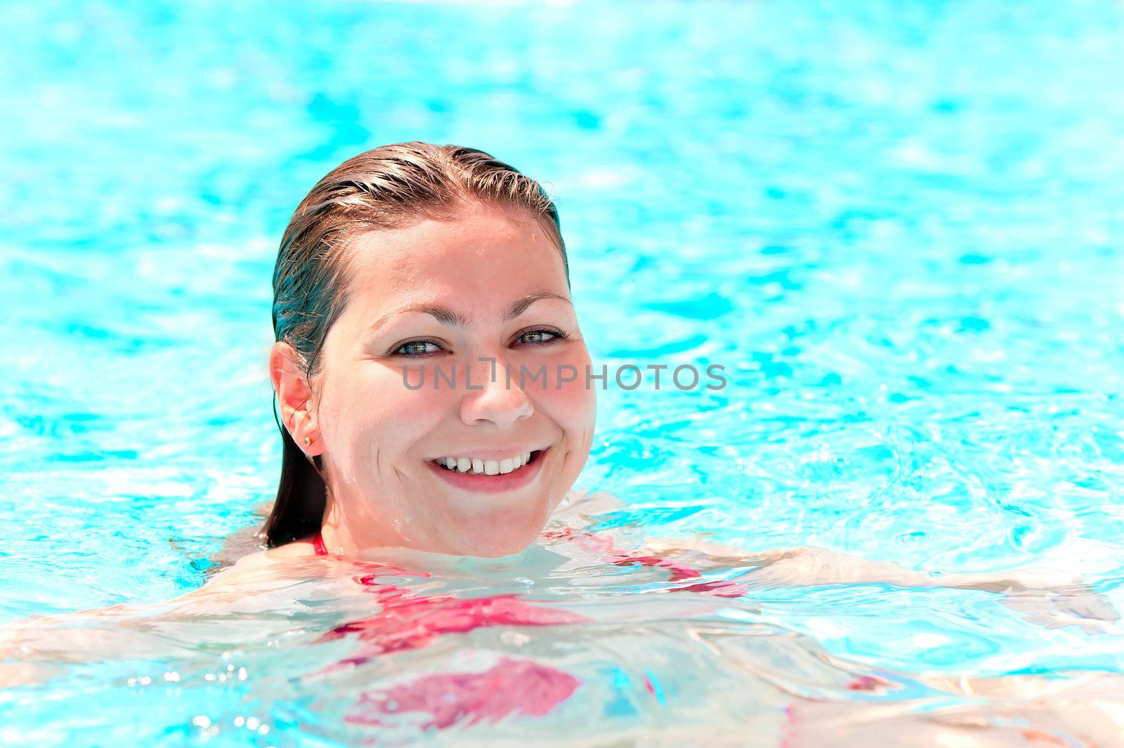 young girl with a beautiful smile swim in the pool by kosmsos111