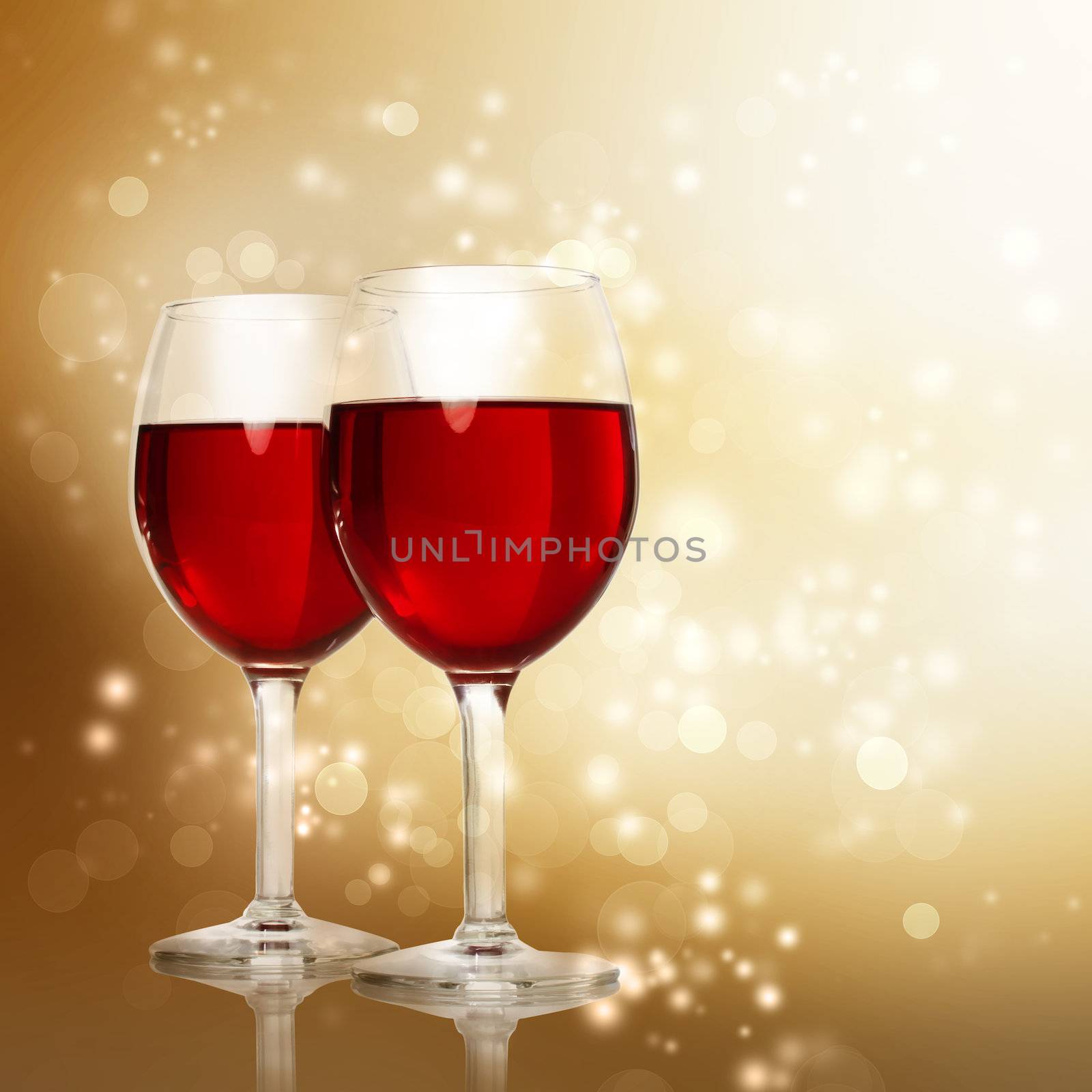 Two Red Wine Glasses on a Gold Sparkling Backdrop