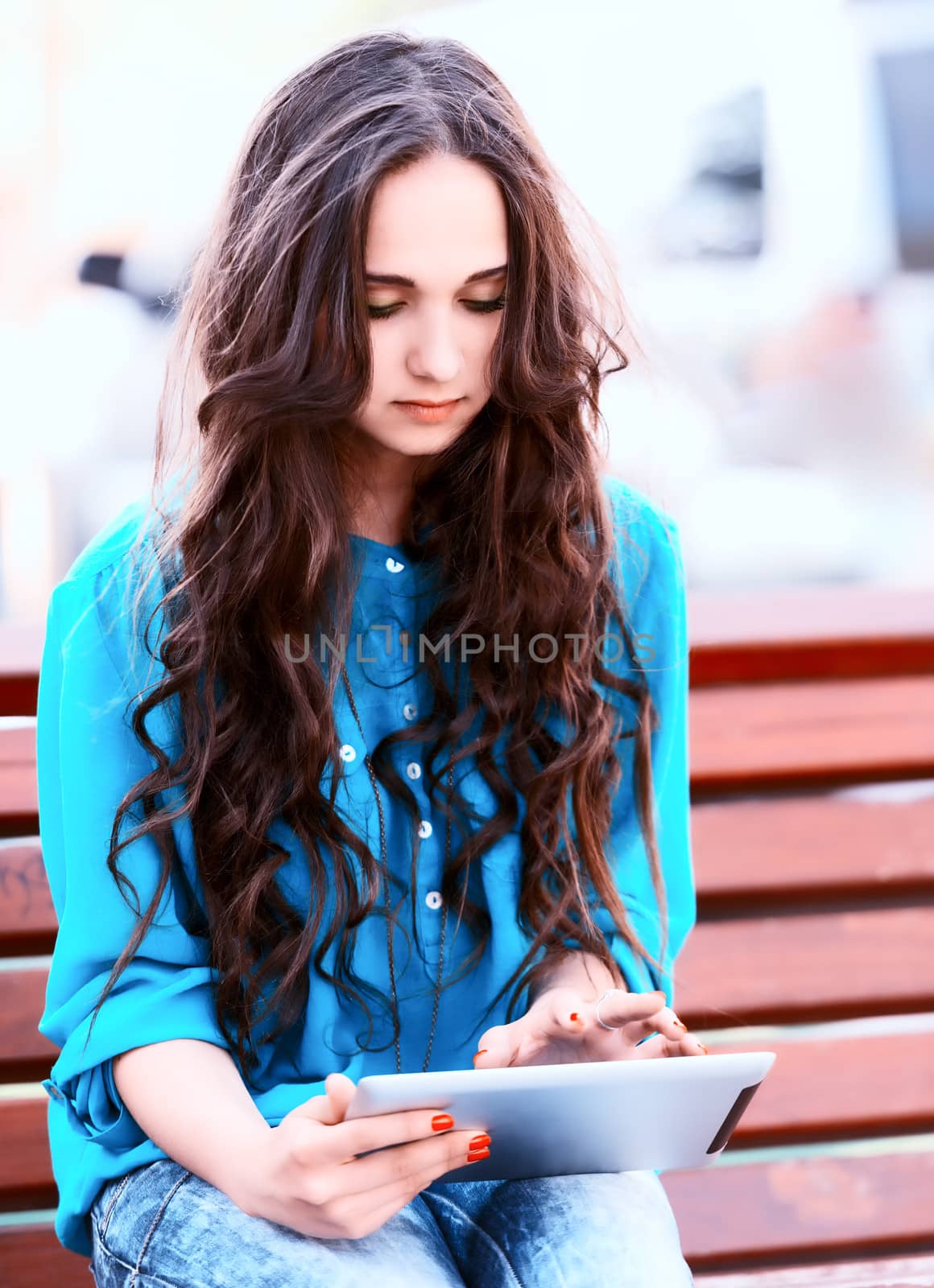 Young woman using tablet by Emevil
