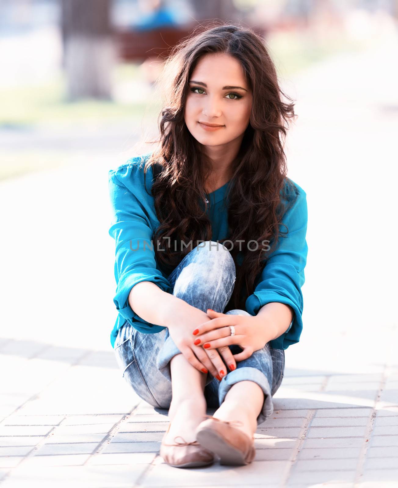 beautiful young girl sitting on a way