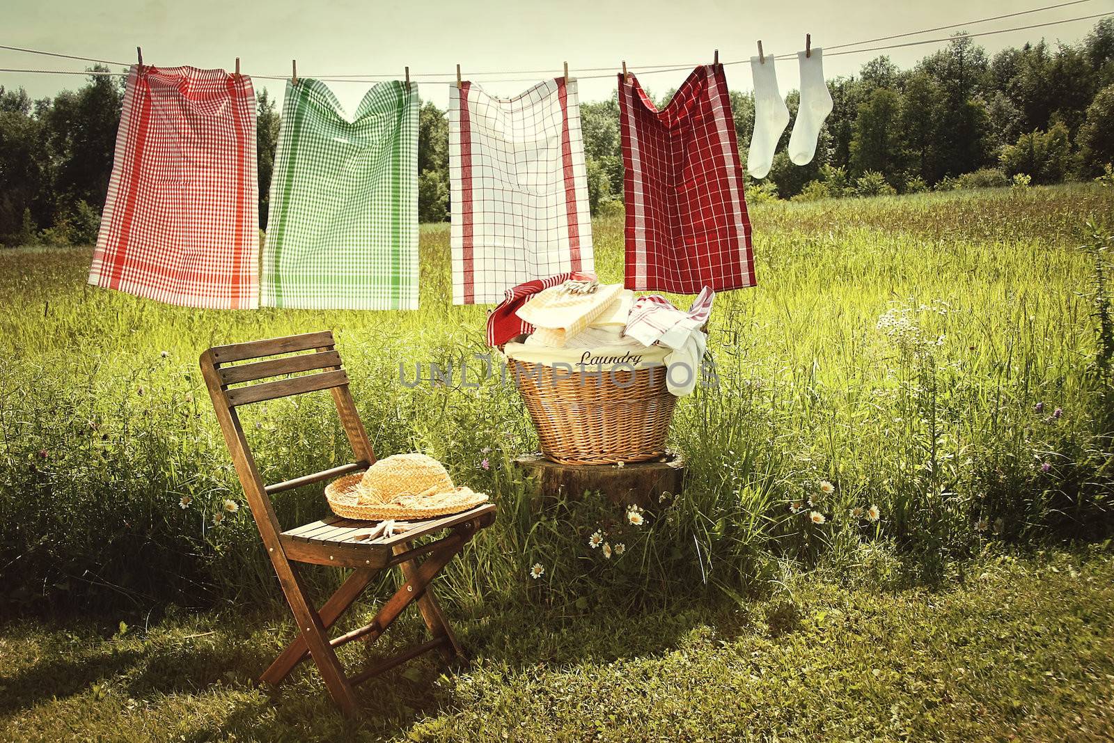 Washing day with laundry on clothesline by Sandralise