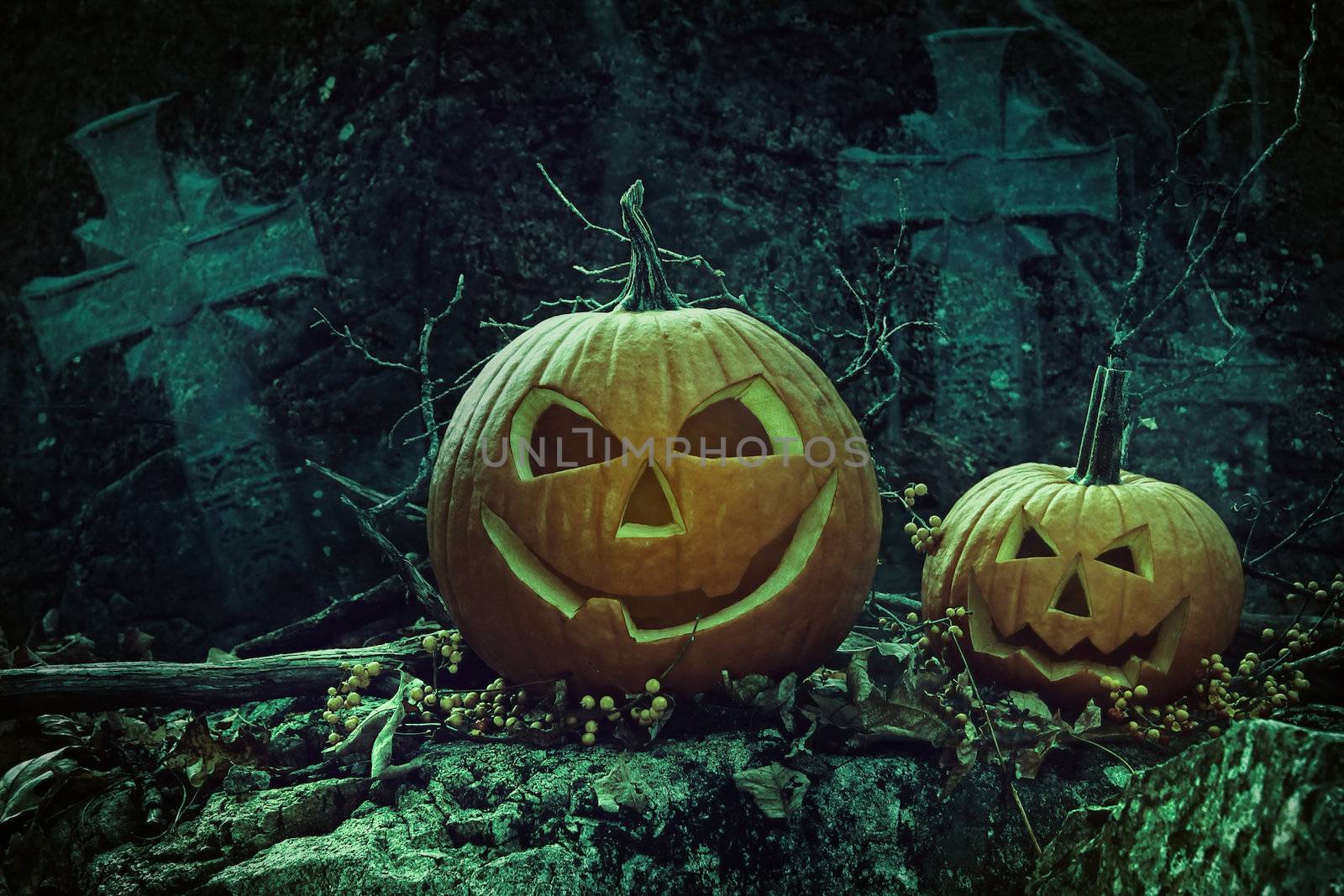 Halloween pumpkins in graveyard at night by Sandralise