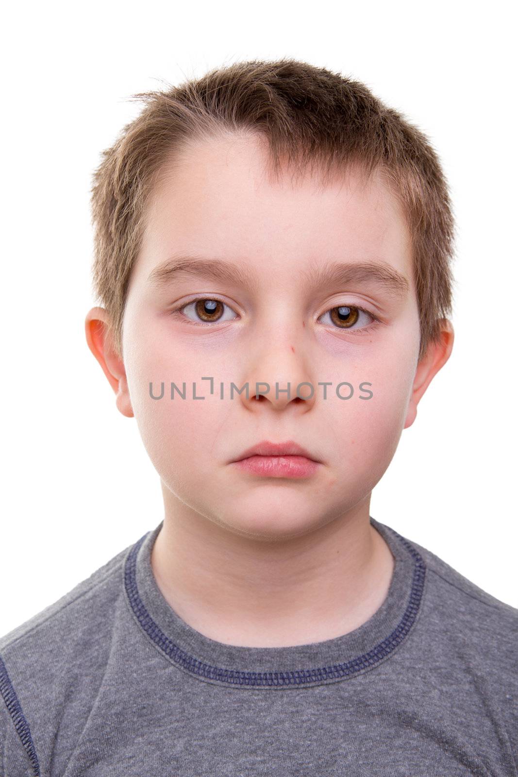 Sad kid having depression, that you can see in his eyes, shoulders and expression, isolated on white,