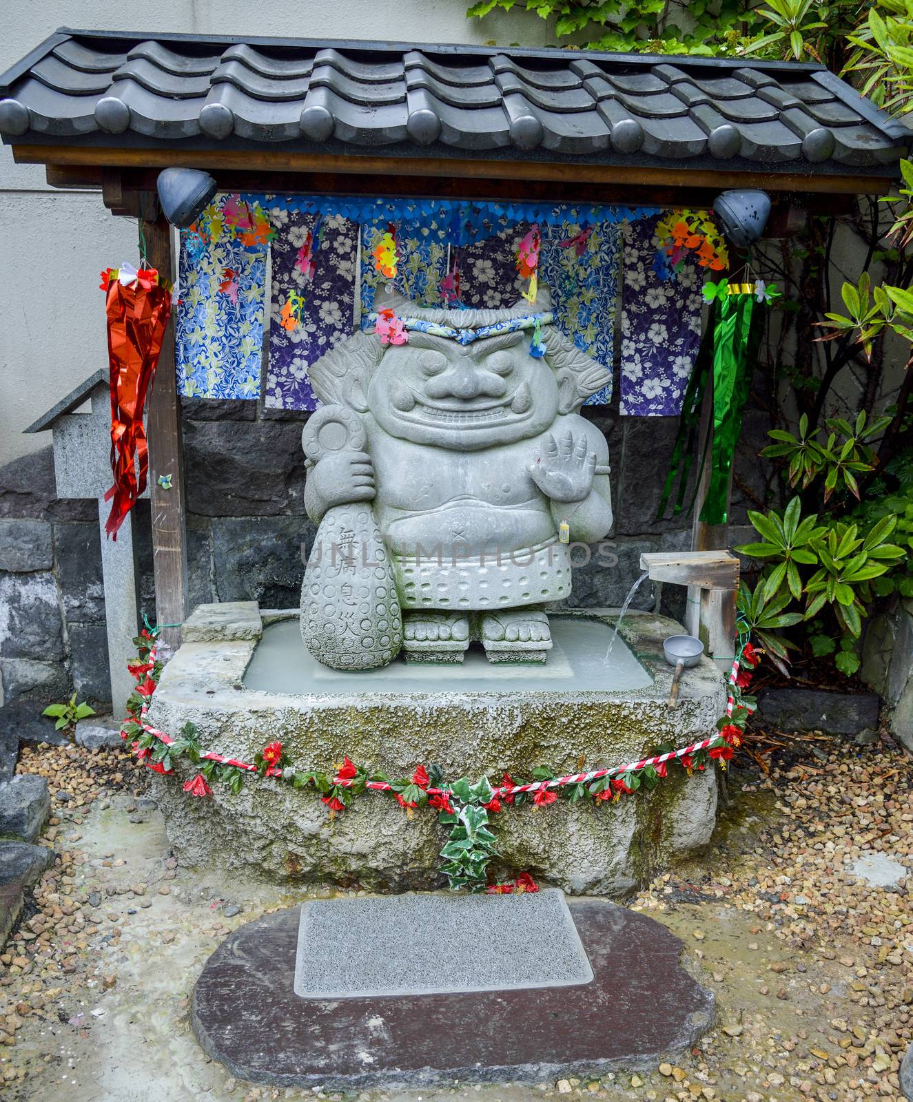 Small shrine with little giant stone by gjeerawut