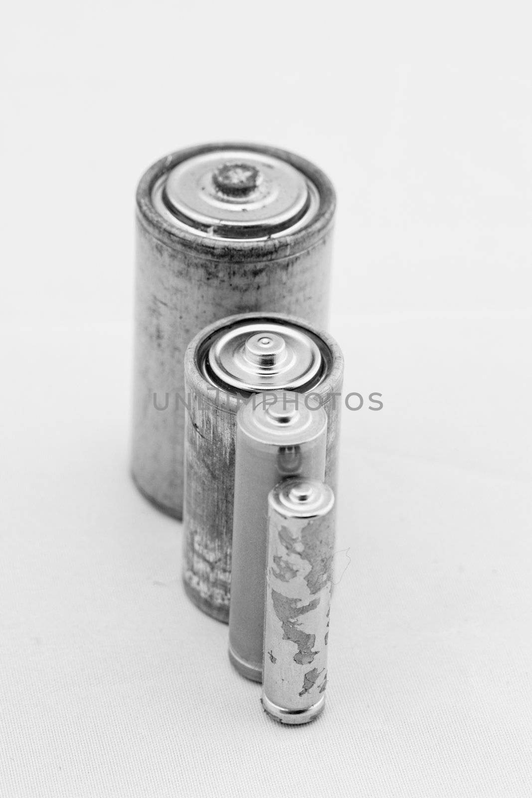 Old batteries on white background by NagyDodo