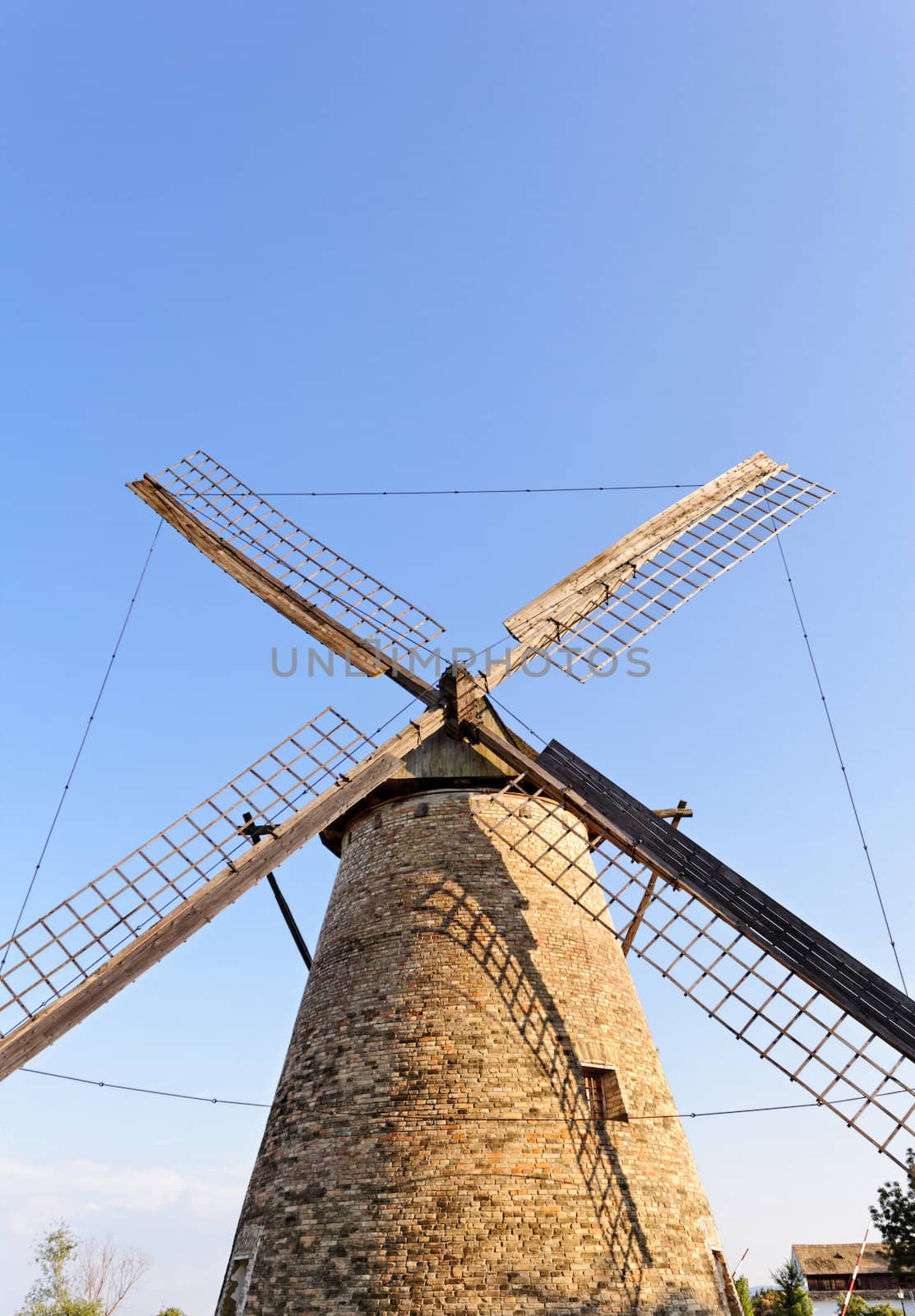 Old wooden windmill against the blue sky