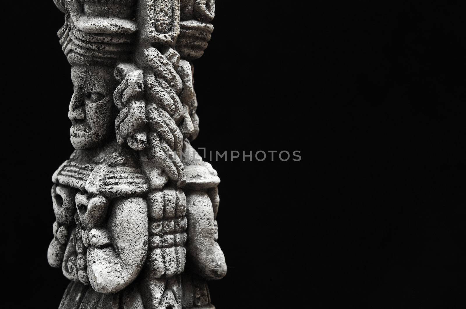 One Ancient Mayan Statue on a Black Background