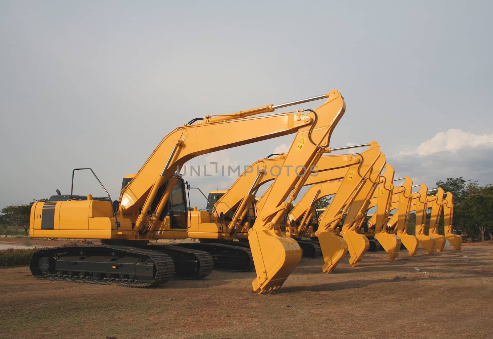 Lineup of Construction Vehicles At Construction Site