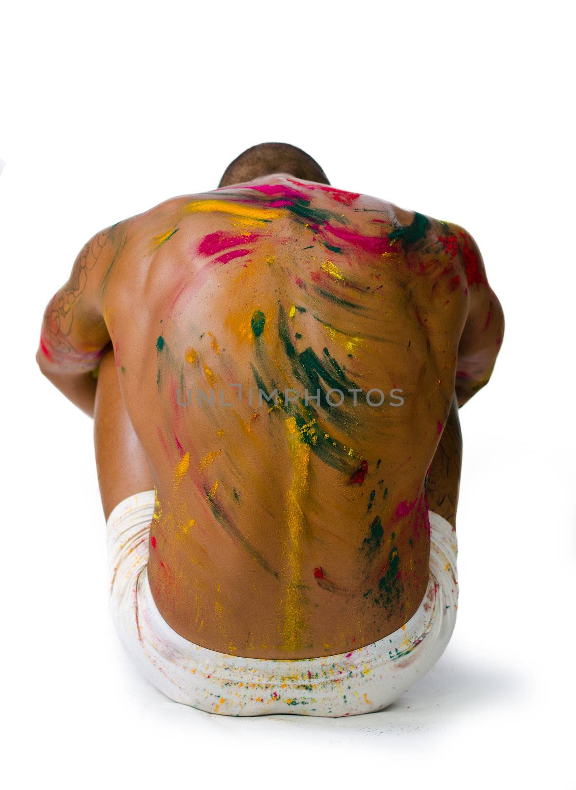 Muscular back of shirtless young man with skin painted all over with bright colors by artofphoto
