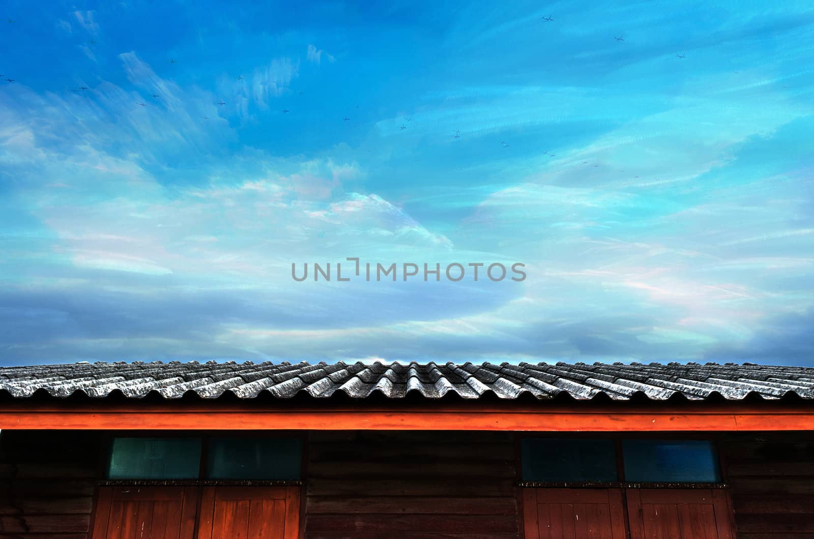 The Moving Planes, Cloudy Blue Sky and Roof of Wooden House.