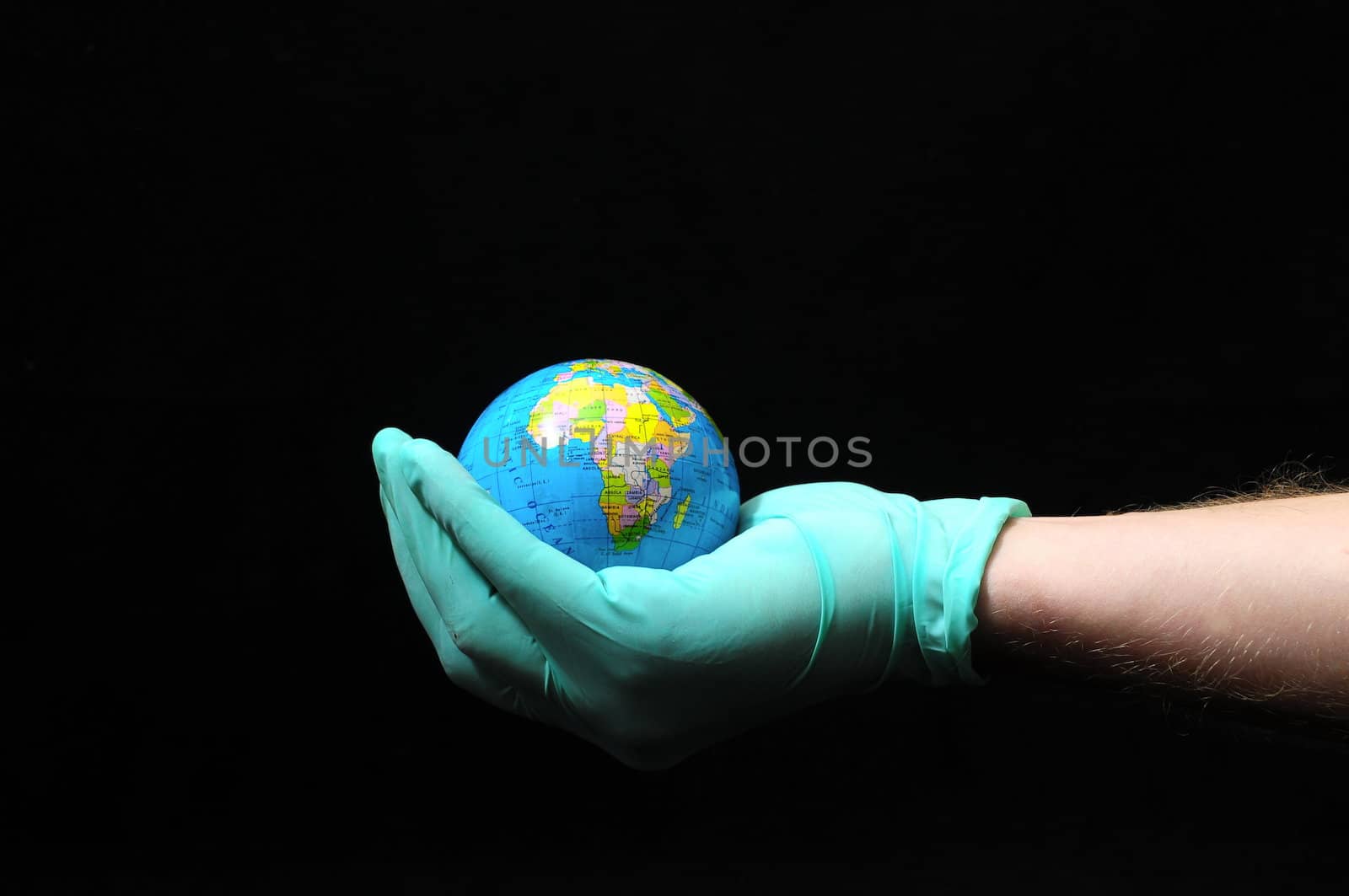 Planet Earth and a Hand on a Black Background