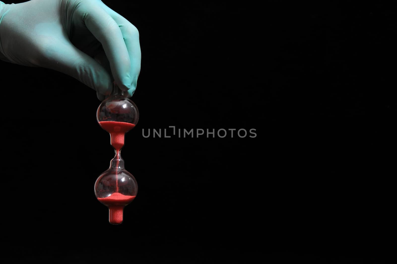 Clock And an Hand on a Black Background