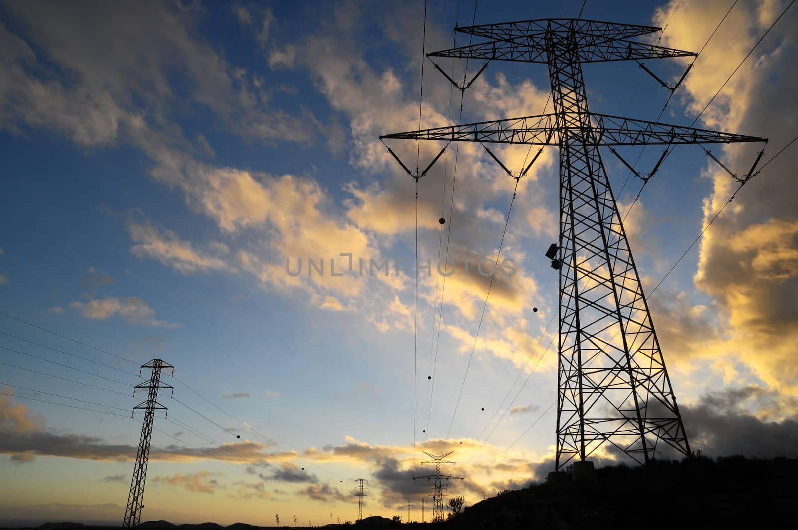 Power Electric Tower on a Cloudy Sky at Sunset