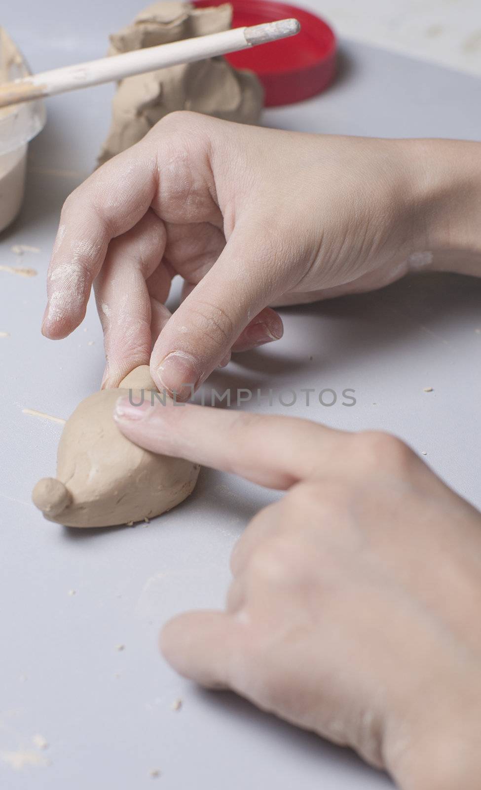 Girl make toyfrom clay. High resolution image.