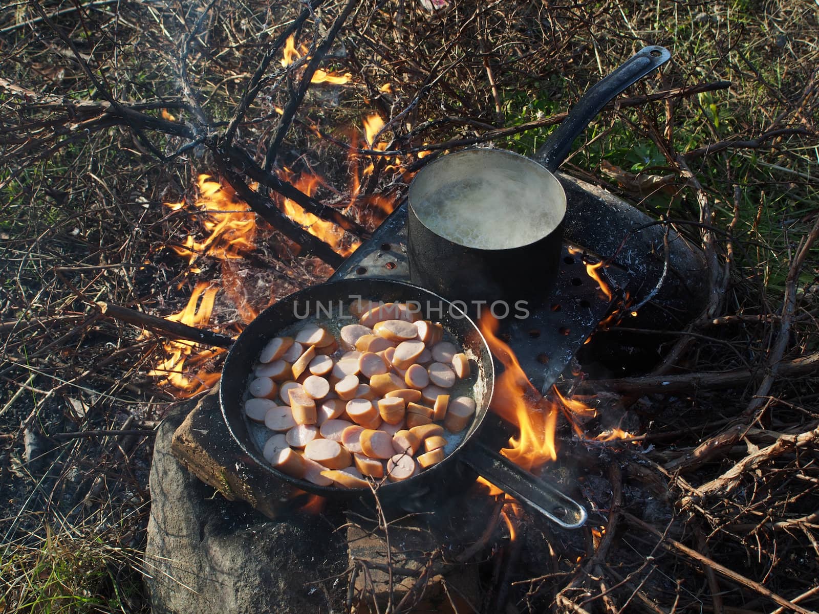 Frying pan and a pot on the fire