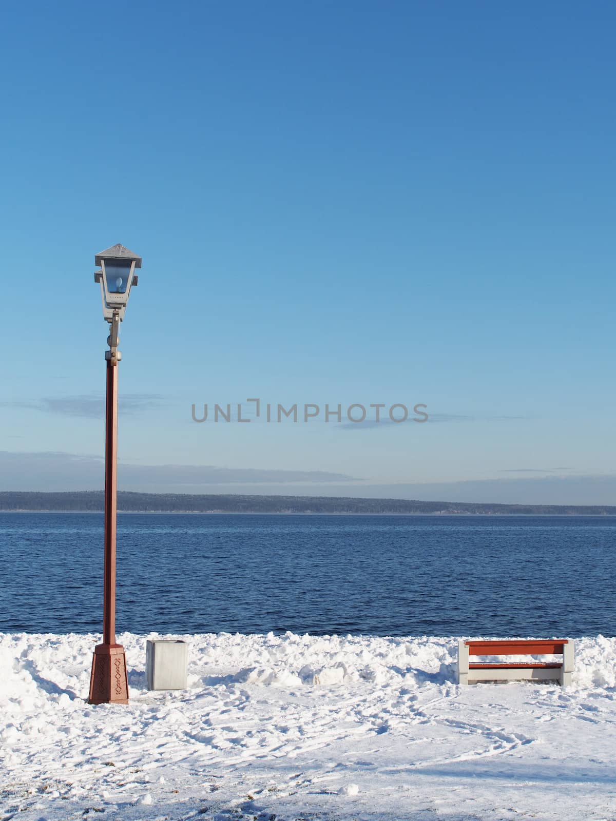 bench and lantern on the quay in winter