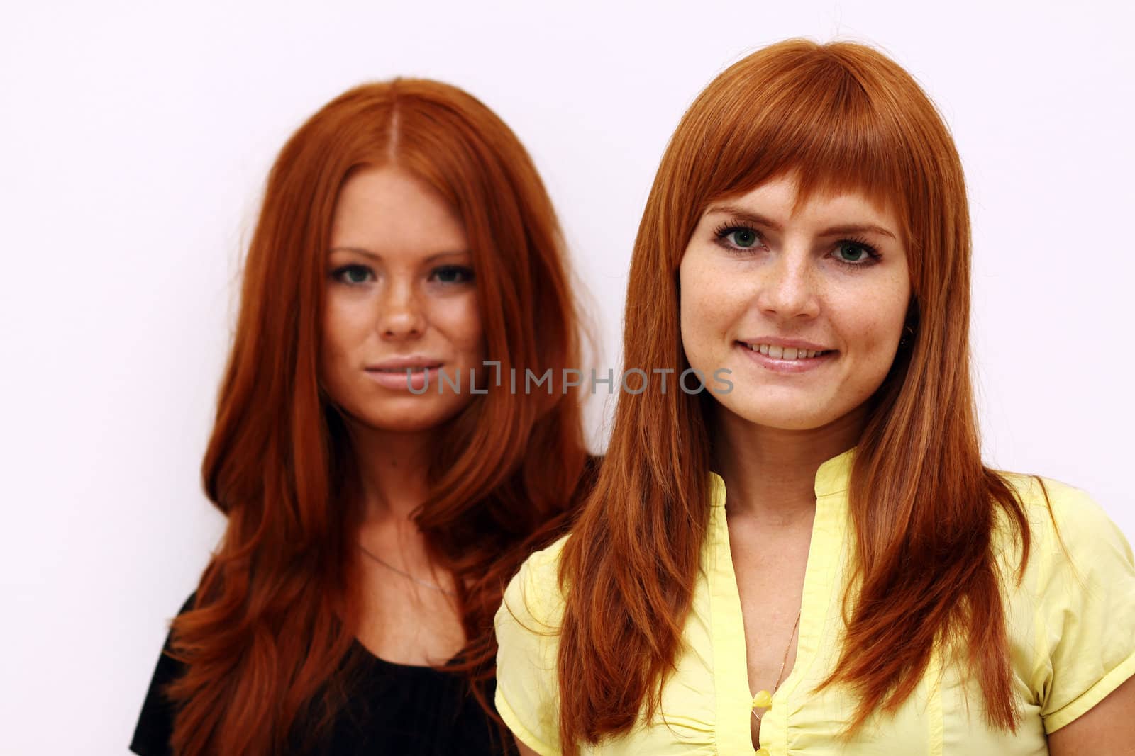 Two young beautiful redhead women