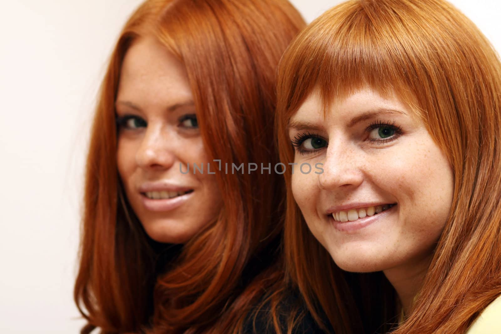 Two young beautiful redhead women