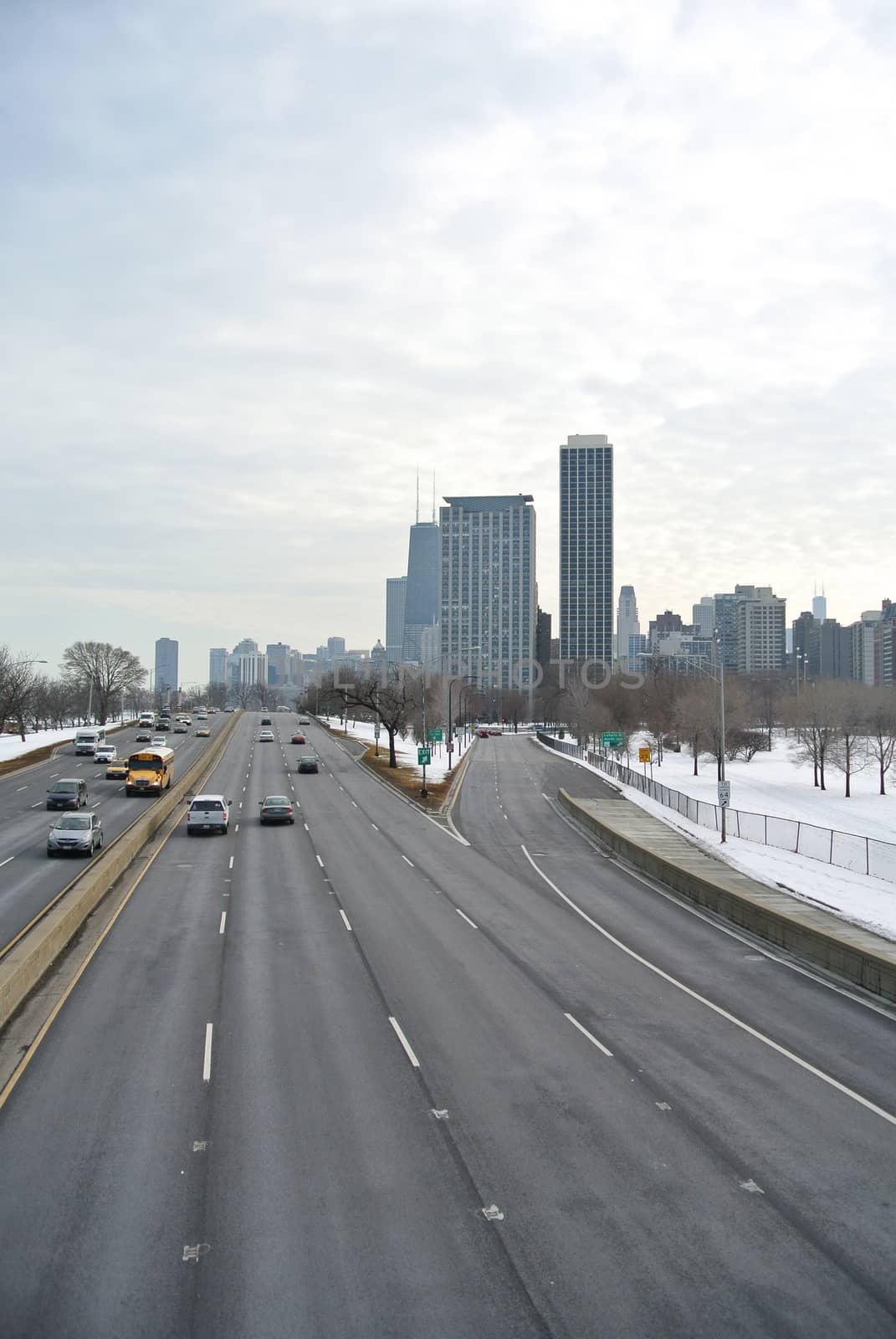 Chicago highway with snowy weather with copyspace on the road and grouped cars.