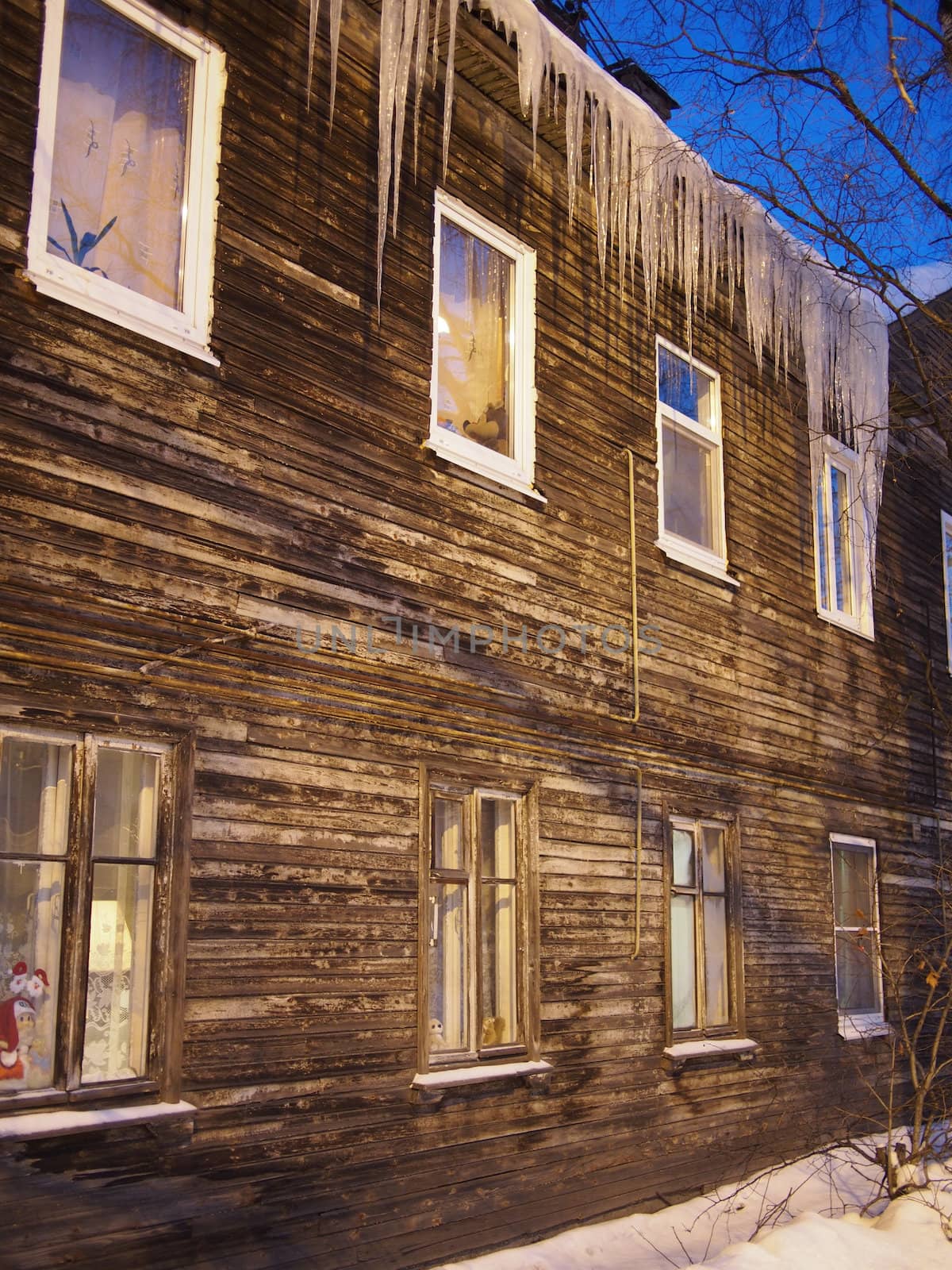 Icicles on the roof of a wooden house