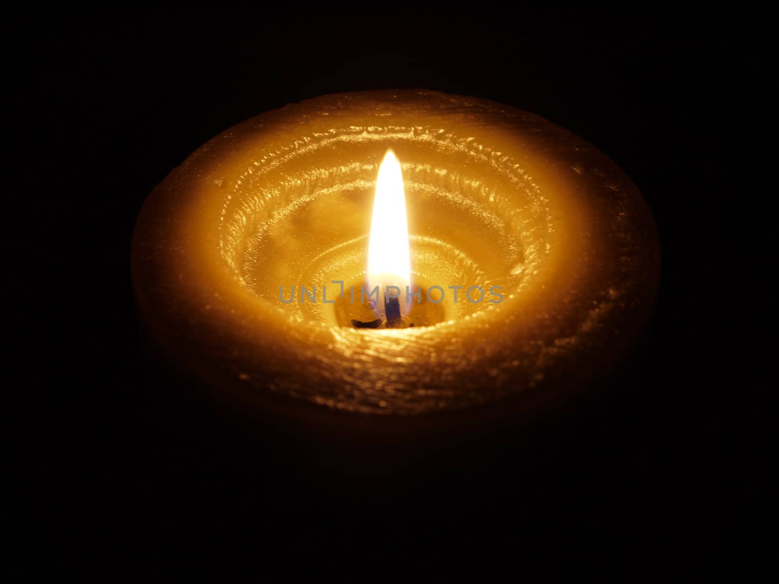 Candle on black background