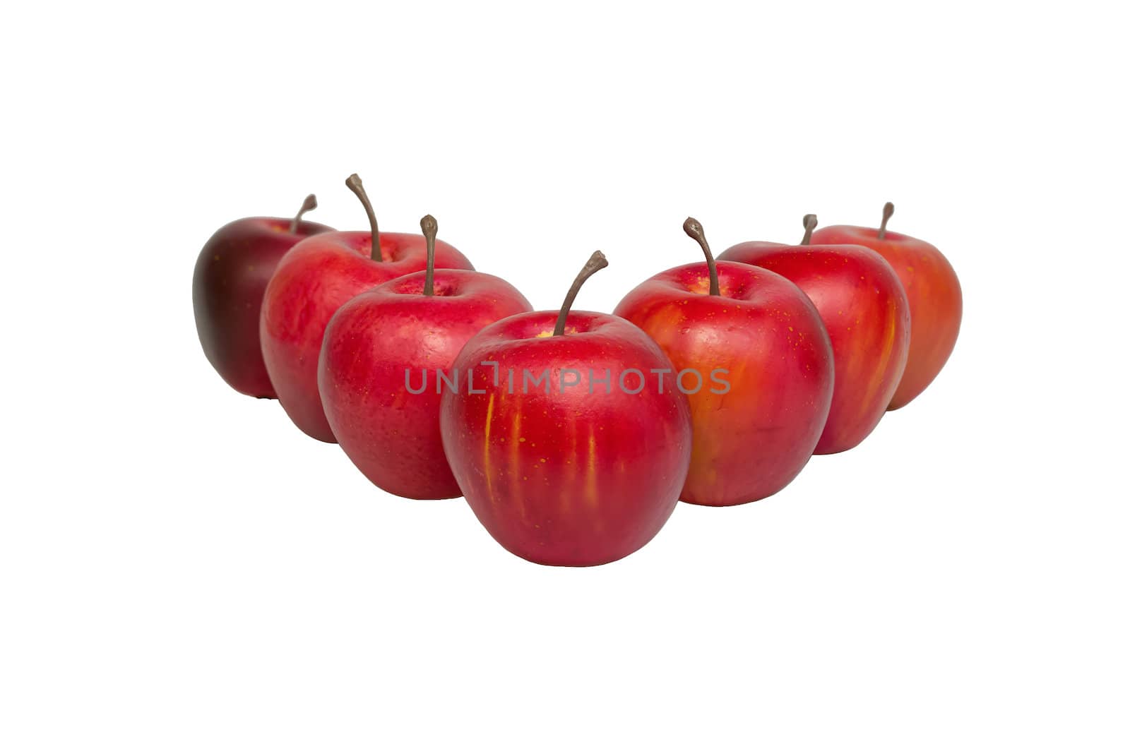 Seven red apples are arranged in a V-shape formation.