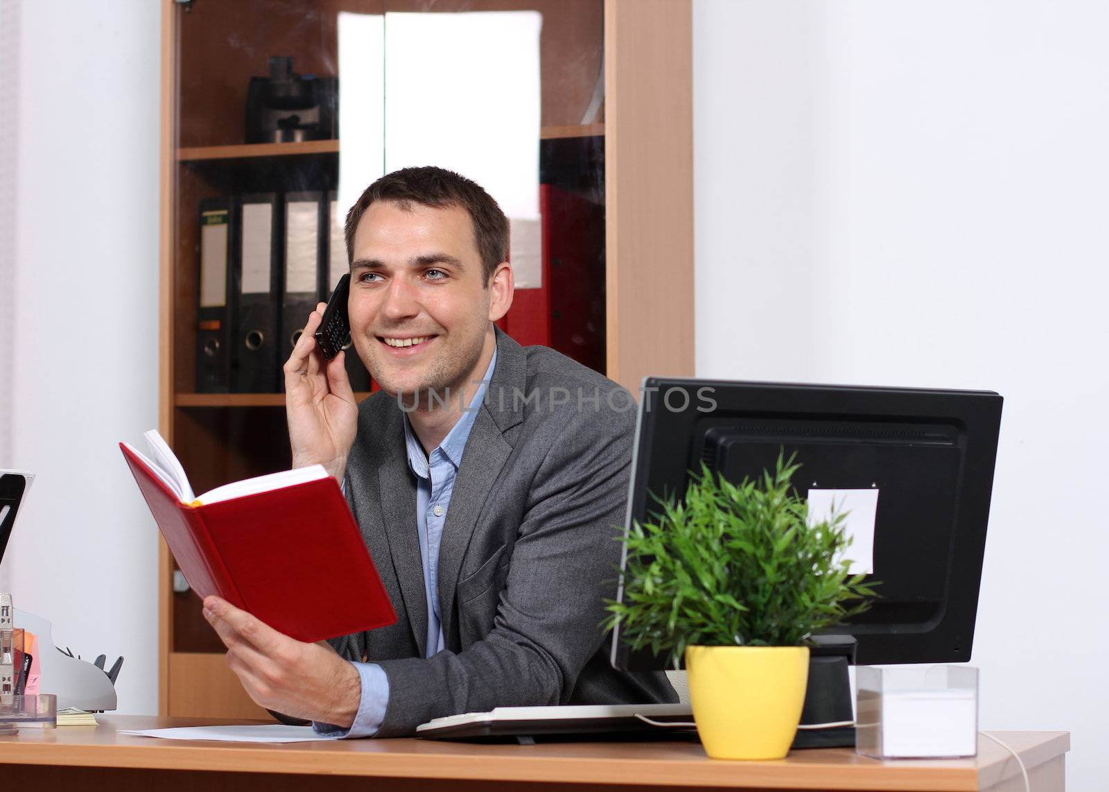 Smiling man talking on mobile phone