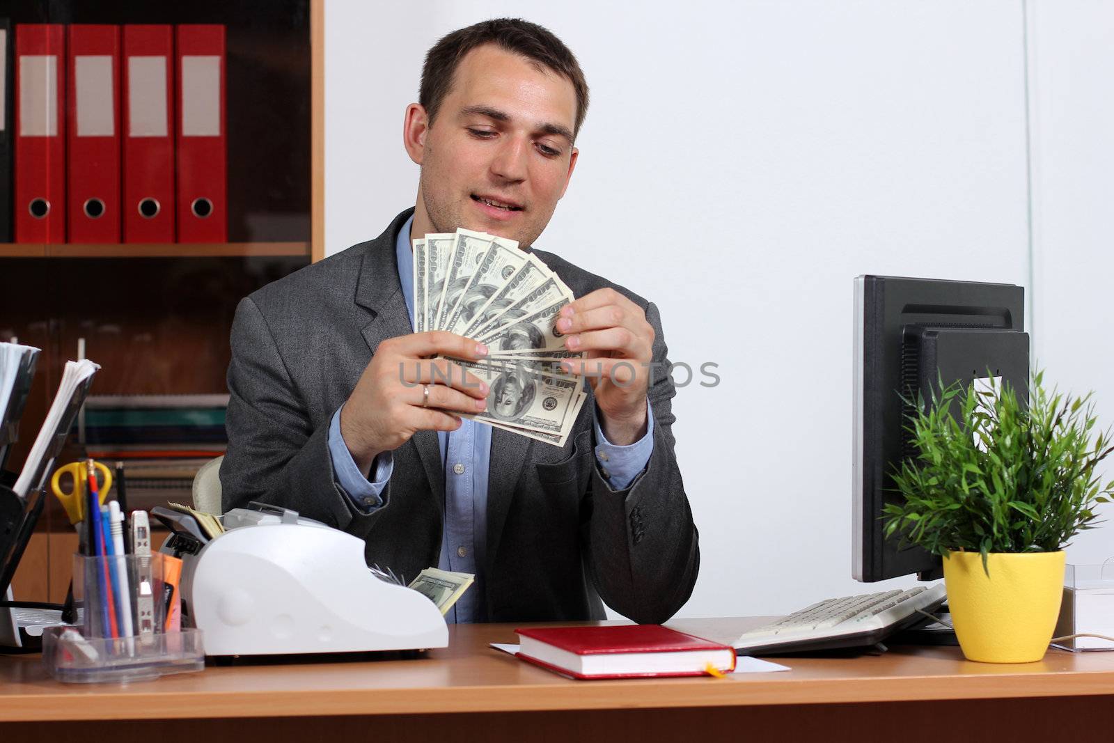 A young man with dollars in their hands