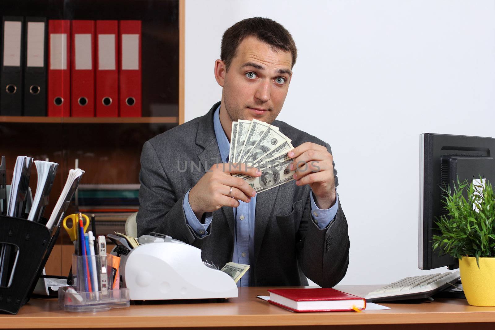 A young man with dollars in their hands