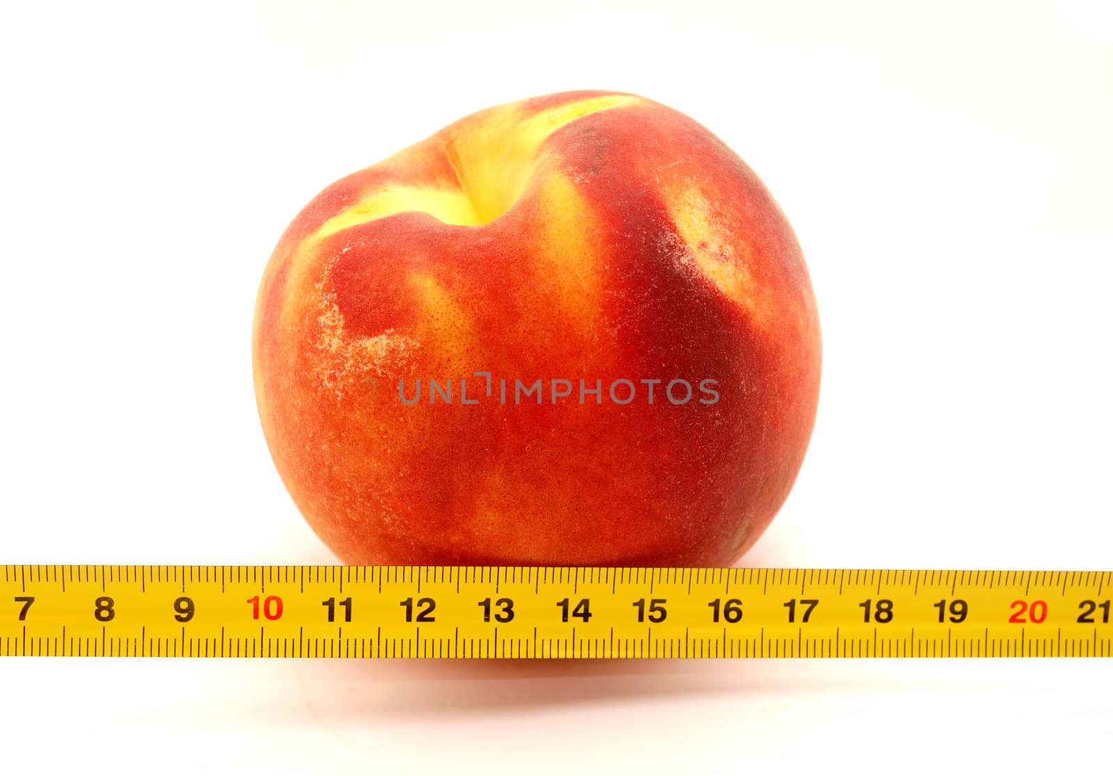 Peach and ruler on a white background    
